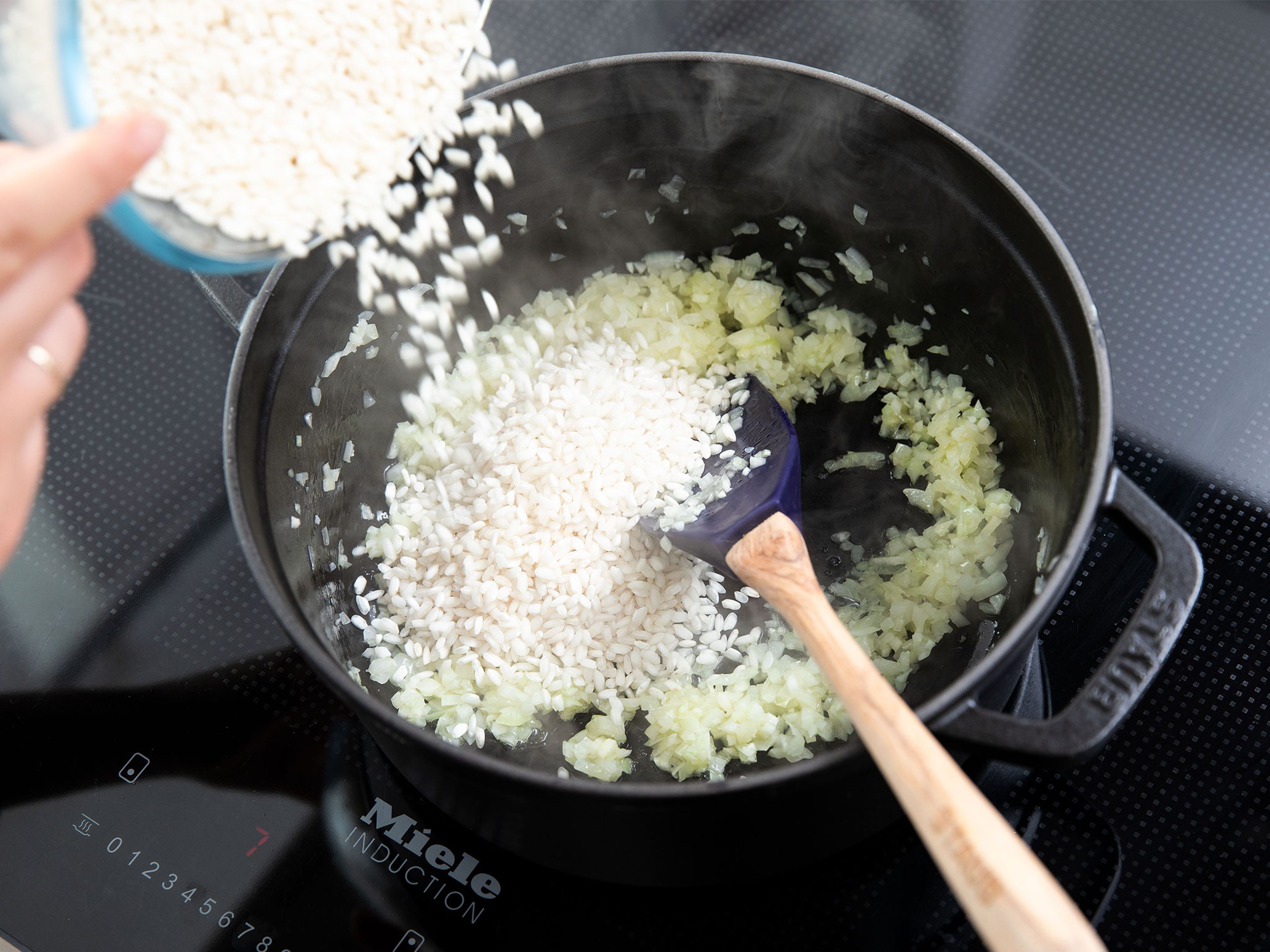 Heat half of the olive oil in a large pot over medium heat and fry onion and garlic until translucent. Add risotto rice and keep frying until the rice gets translucent too, approx 5 min.