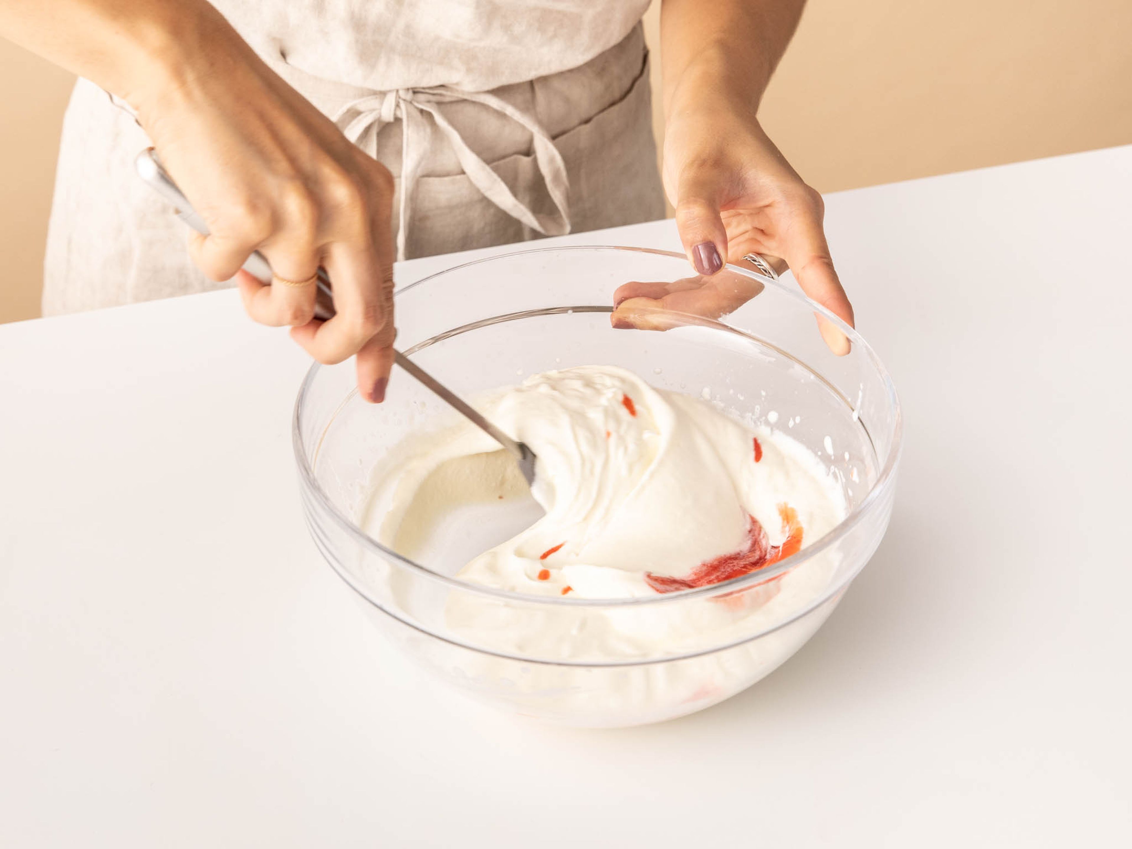 Whip the cream to stiff peaks with remaining sugar. Very gently mix together the strawberry purée and whipped cream just until streaks of the purée are visible.