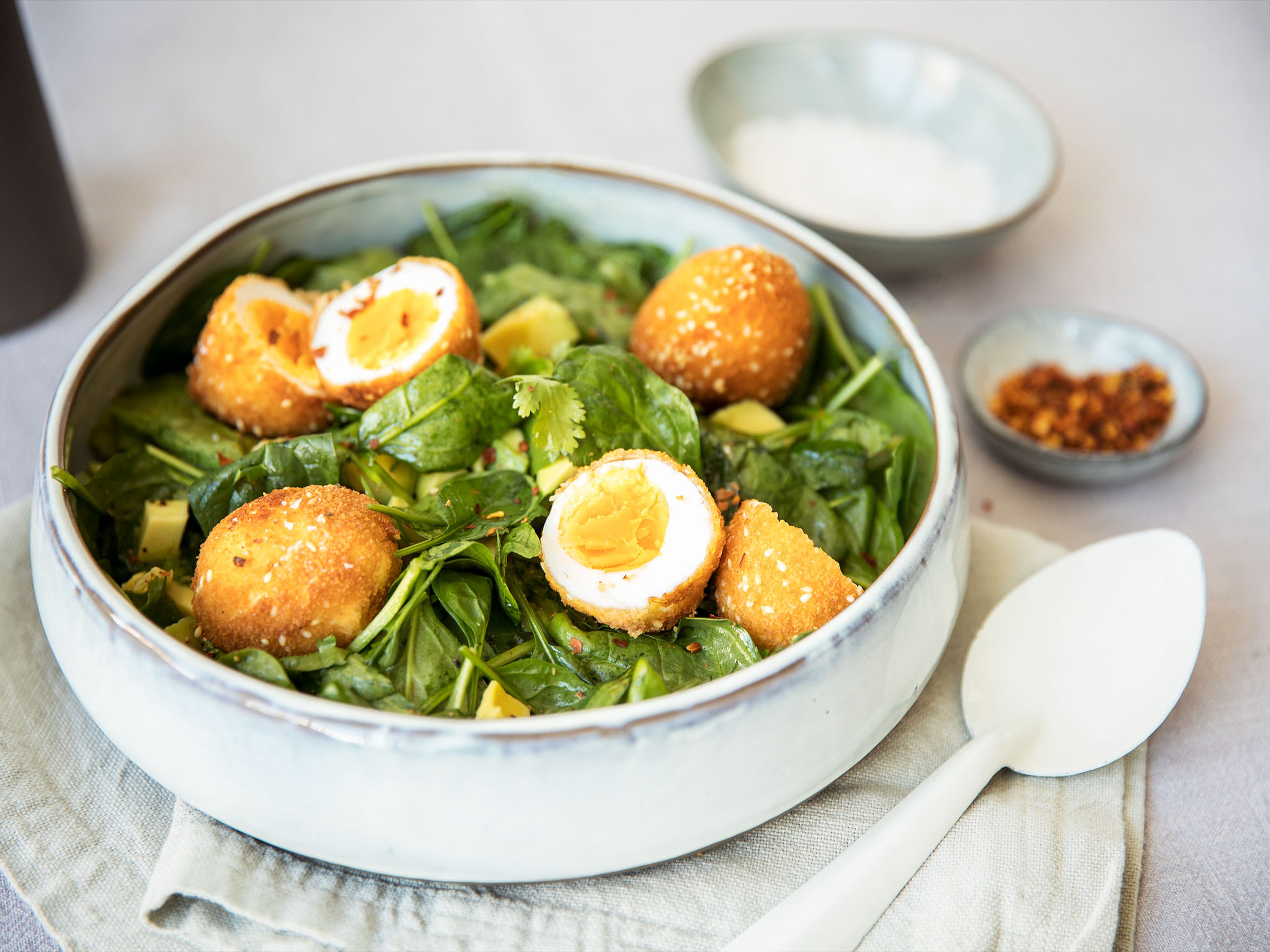 Crispy eggs with cilantro and avocado salad