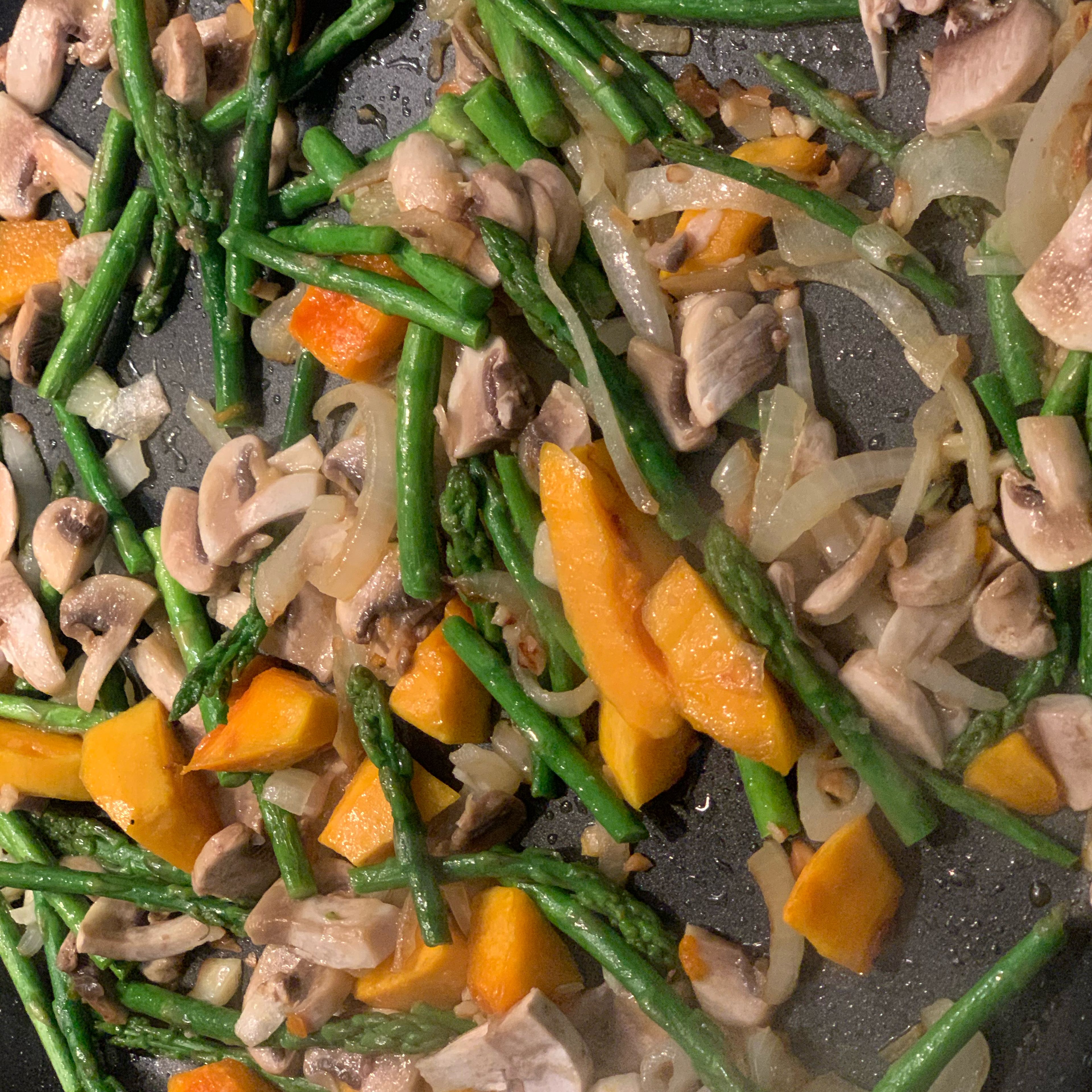 When hot but not smoking add onion and garlic and cook for about 2-3 min. Then add pumpkin and asparagus and sauté for 5-7 min or tender. Finally add mushrooms and season with salt and pepper.