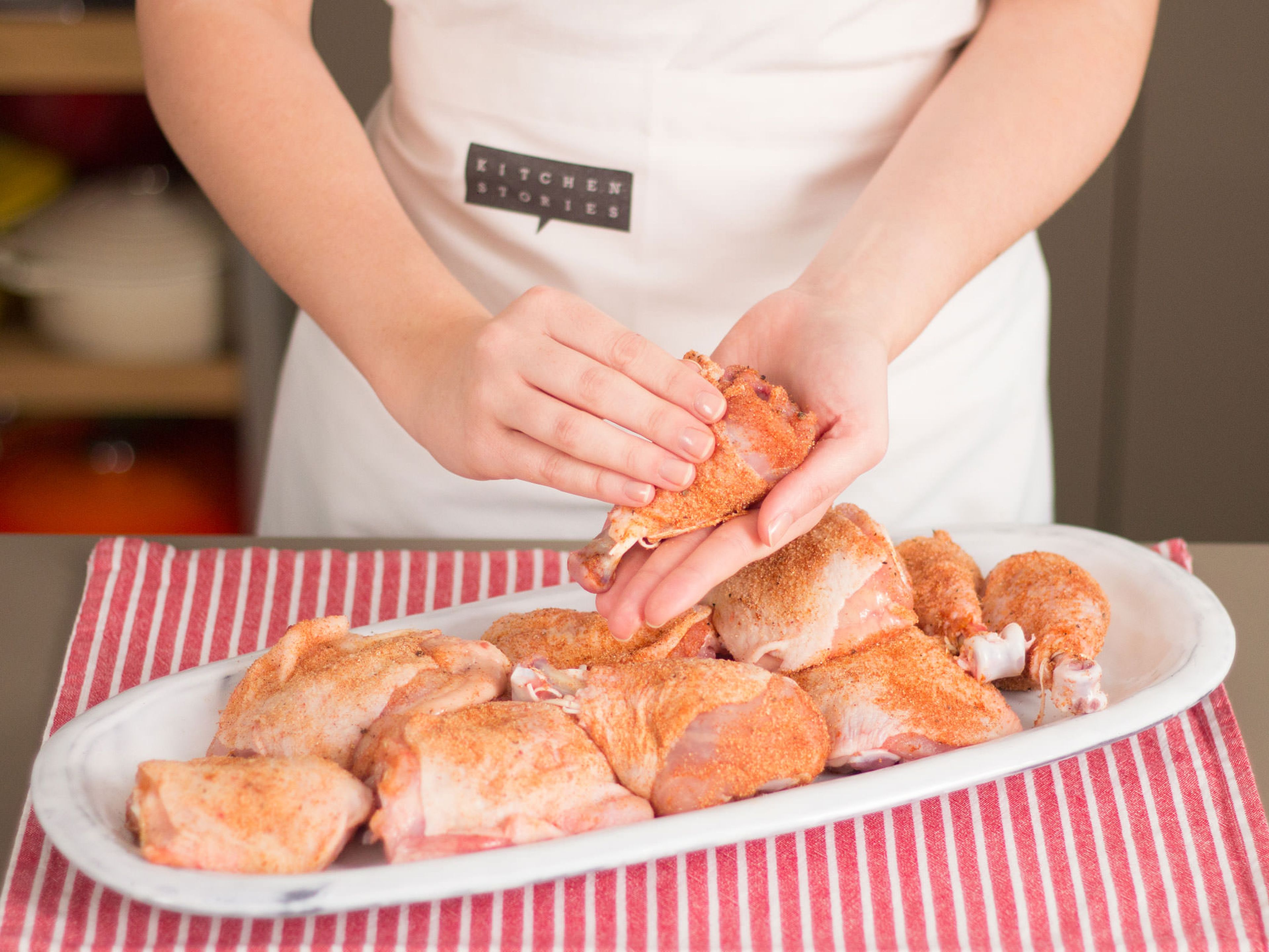 Carefully cut chicken legs in half at the joint. Rub them generously with spice rub, setting any excess spice rub aside.