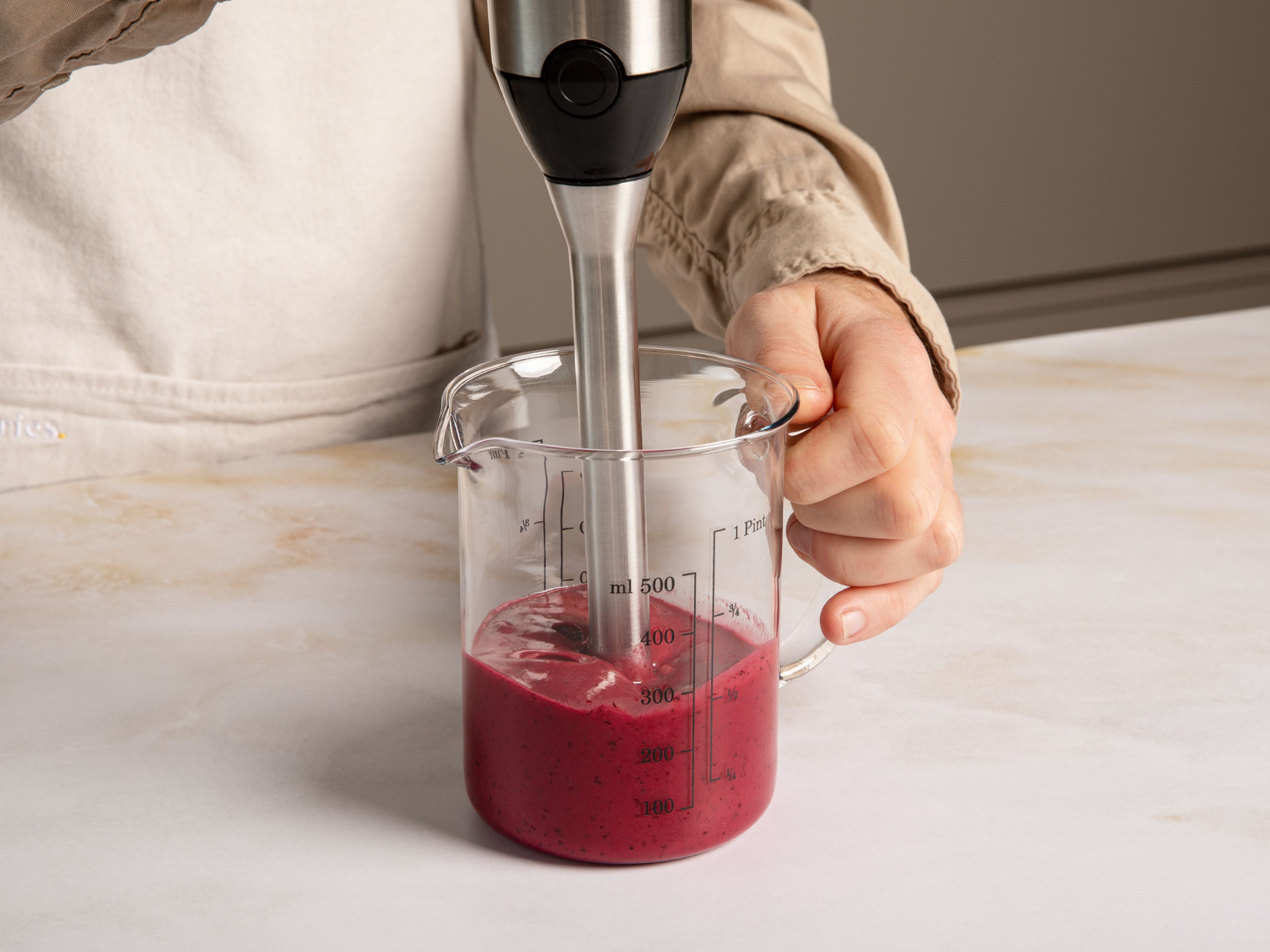 Clean and spin dry the lettuce. For the dressing, in a measuring cup with an immersion blender, purée half of the blueberries with orange juice and zest, mustard, salt, and pepper. Then slowly mix in the oil to make a creamy dressing.