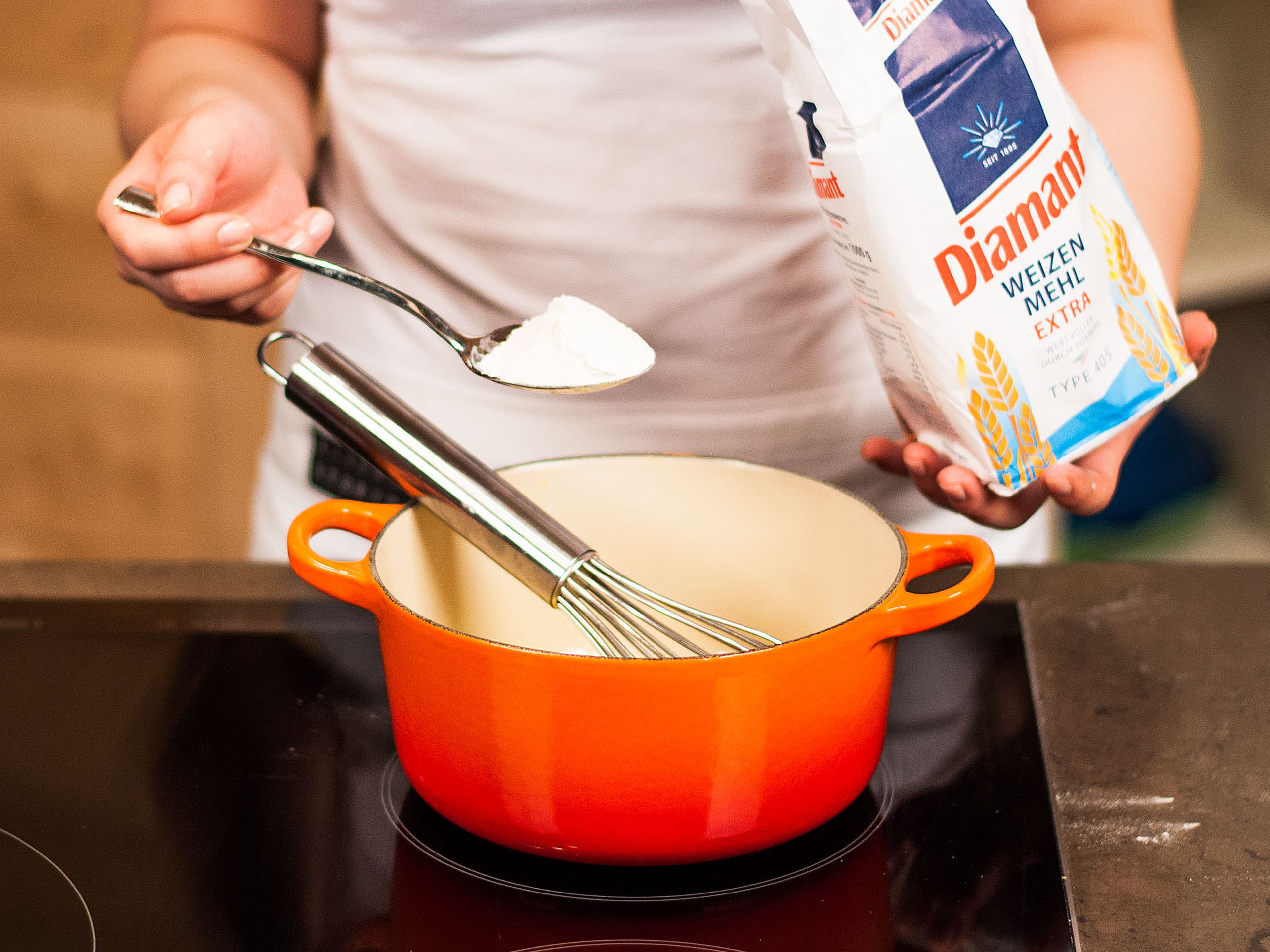 Prepare a roux for the cream sauce. Melt butter in a saucepan, add flour, and stir constantly until there are no more lumps.