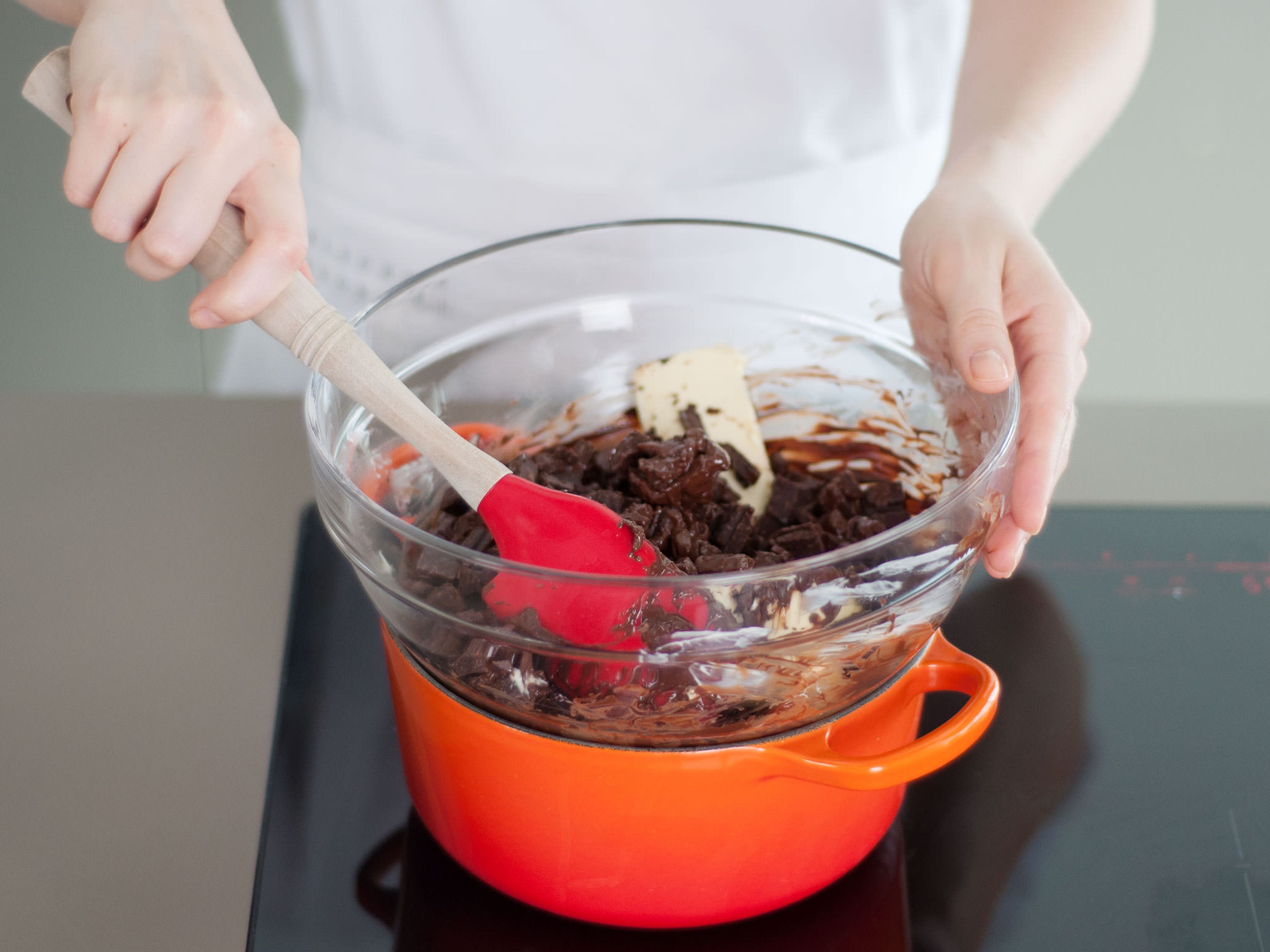 Melt butter and chocolate over a double boiler, stirring occasionally, until combined. Do not stir too much, or the chocolate will seize and lose its shine.