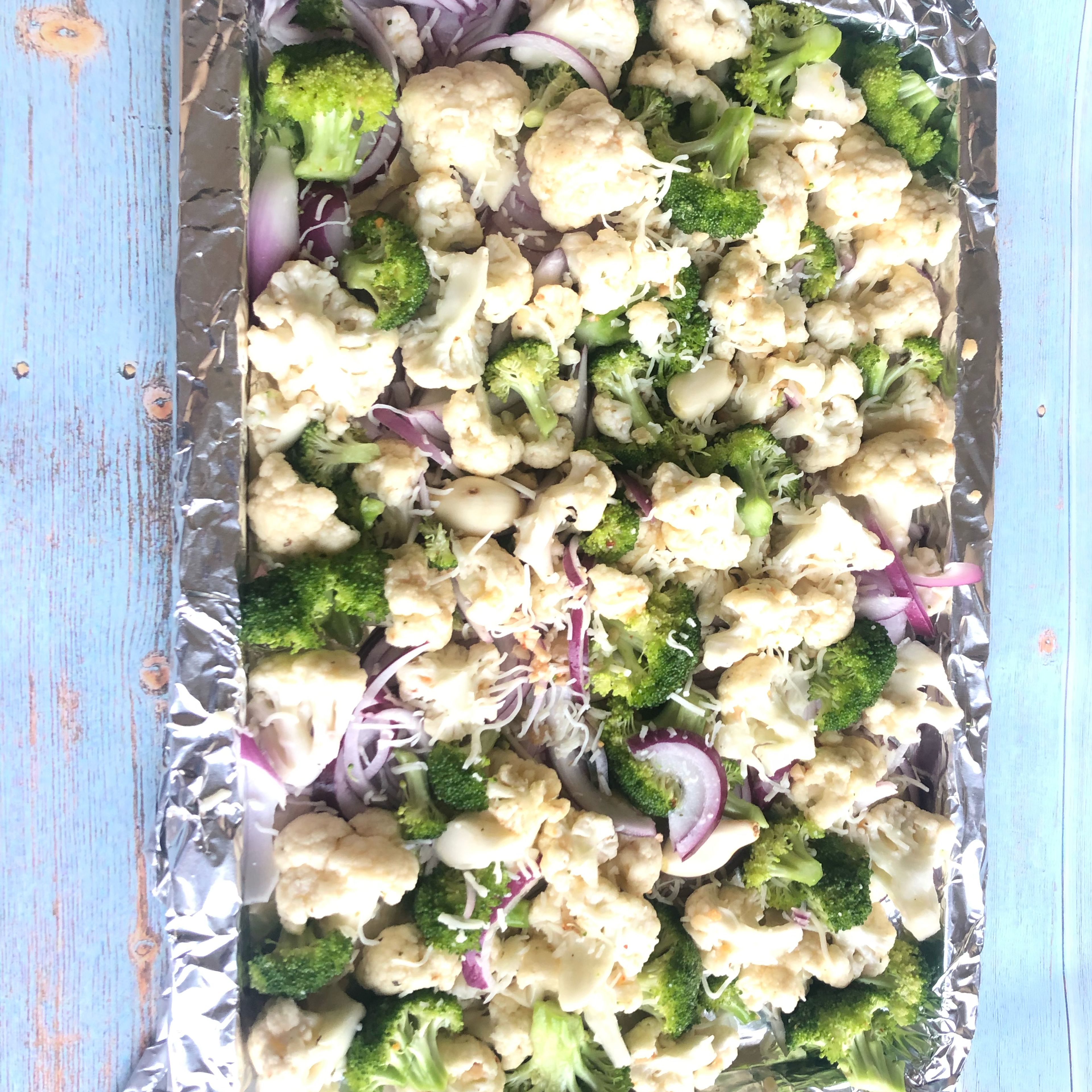 Spread veggies on to a baking sheet. Sprinkle Parmesan cheese over veggies.