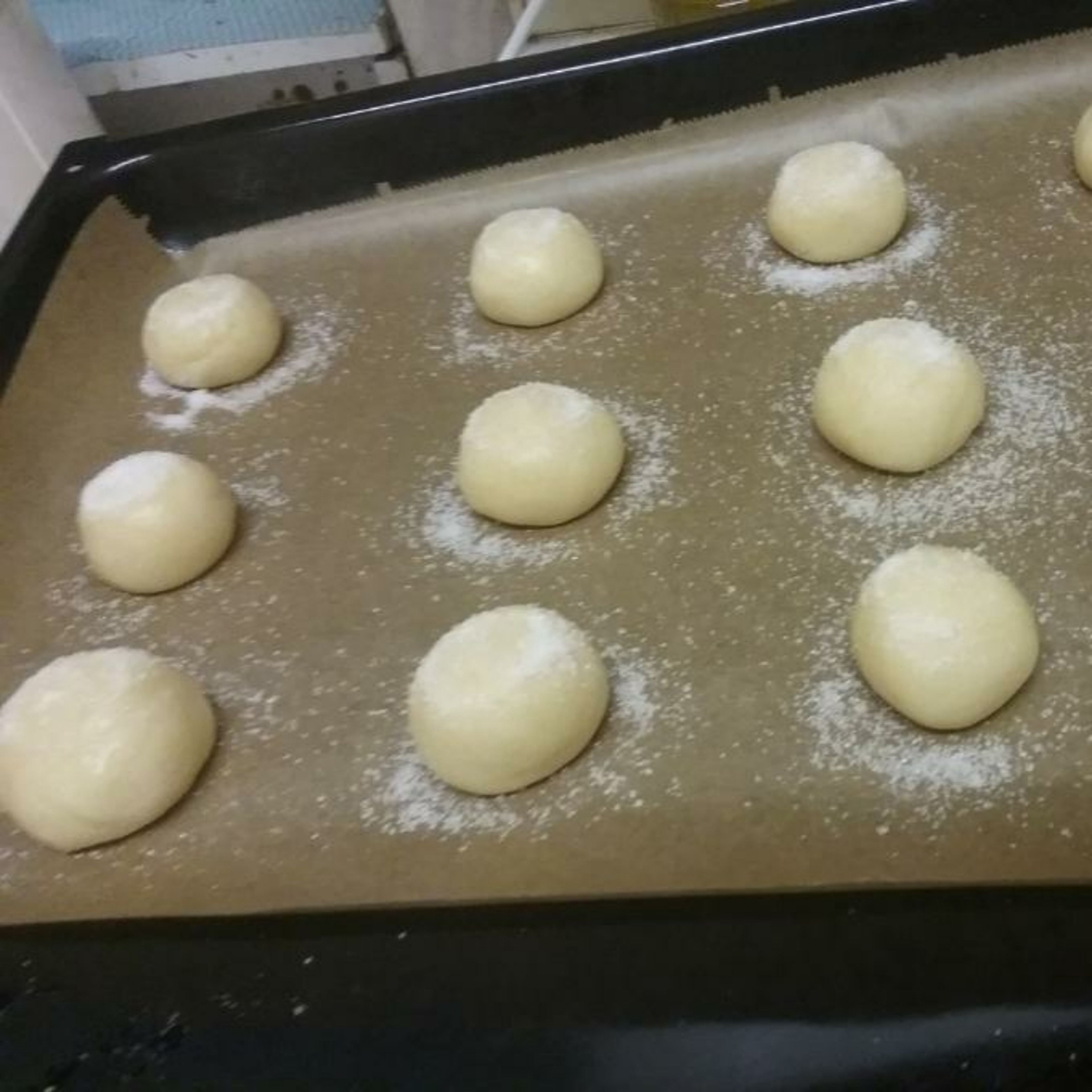 Take the finished batter and roll it into balls. Place it adjacently on the baking sheet, leaving 1 inch/3 centimetres between each ball. After that, sprinkle sugar generously on top of the balls.