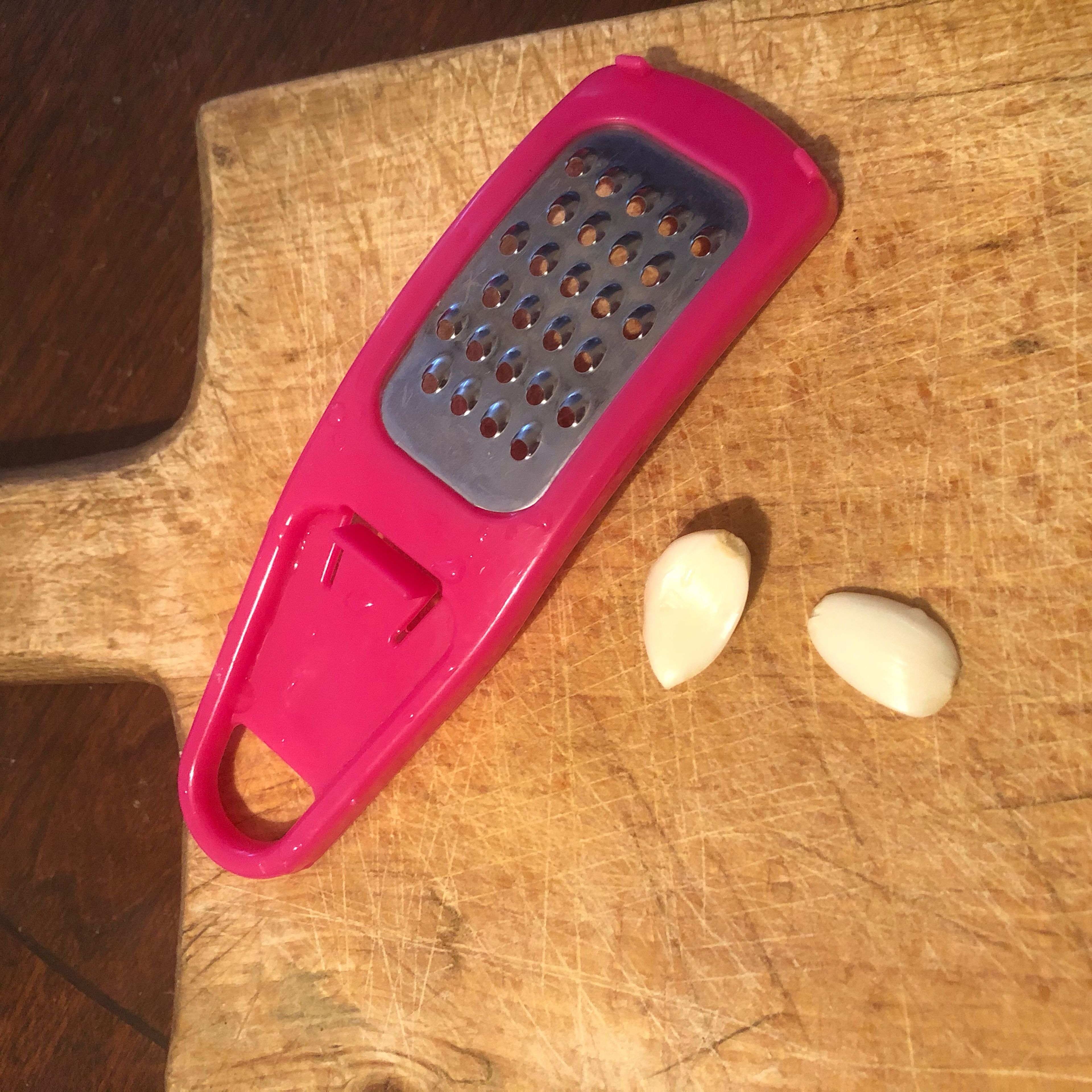 Rub the peeled garlic cloves up and down the grater until the garlic is grated or use knife to finely chop the garlic