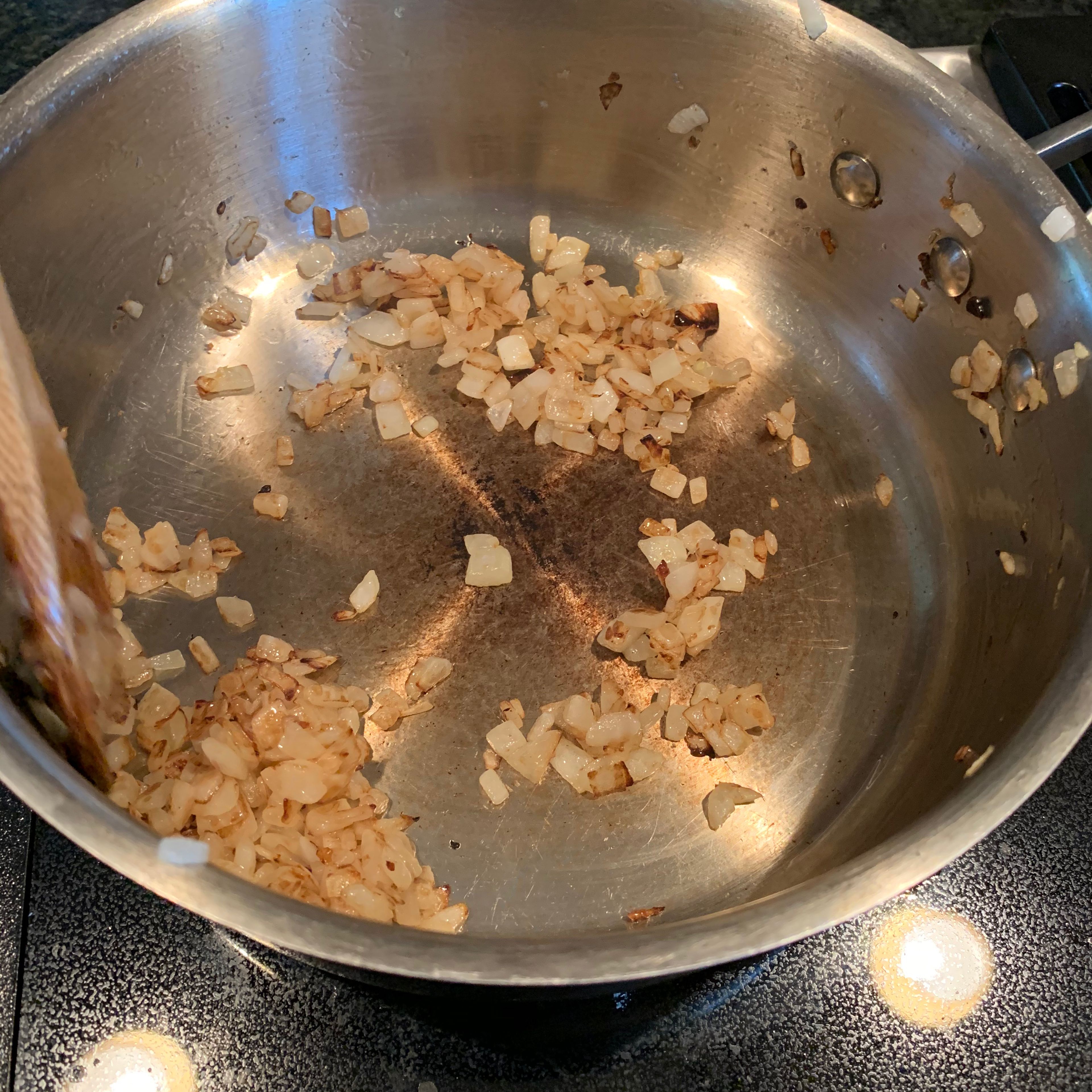In a saucepan, caramelize the chopped onion until golden brown.