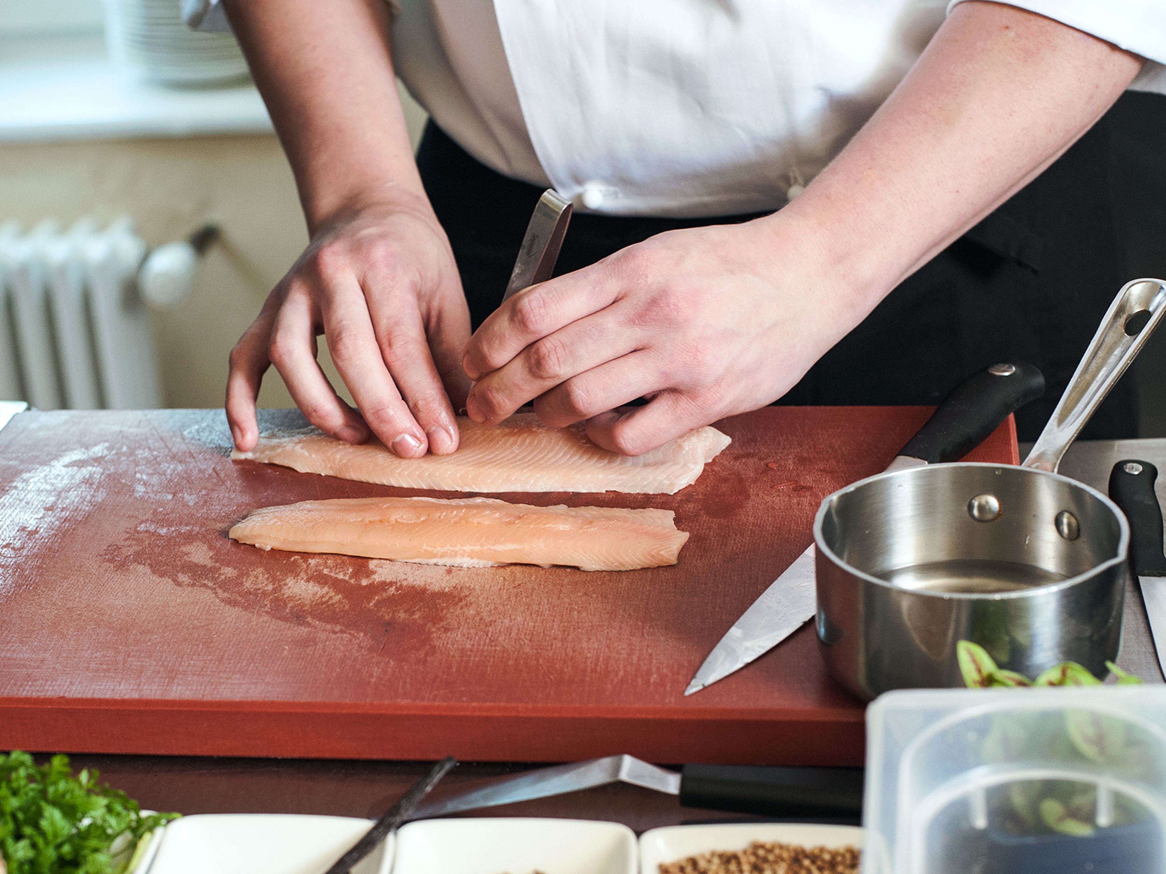 Fillet and remove bones from the arctic char.