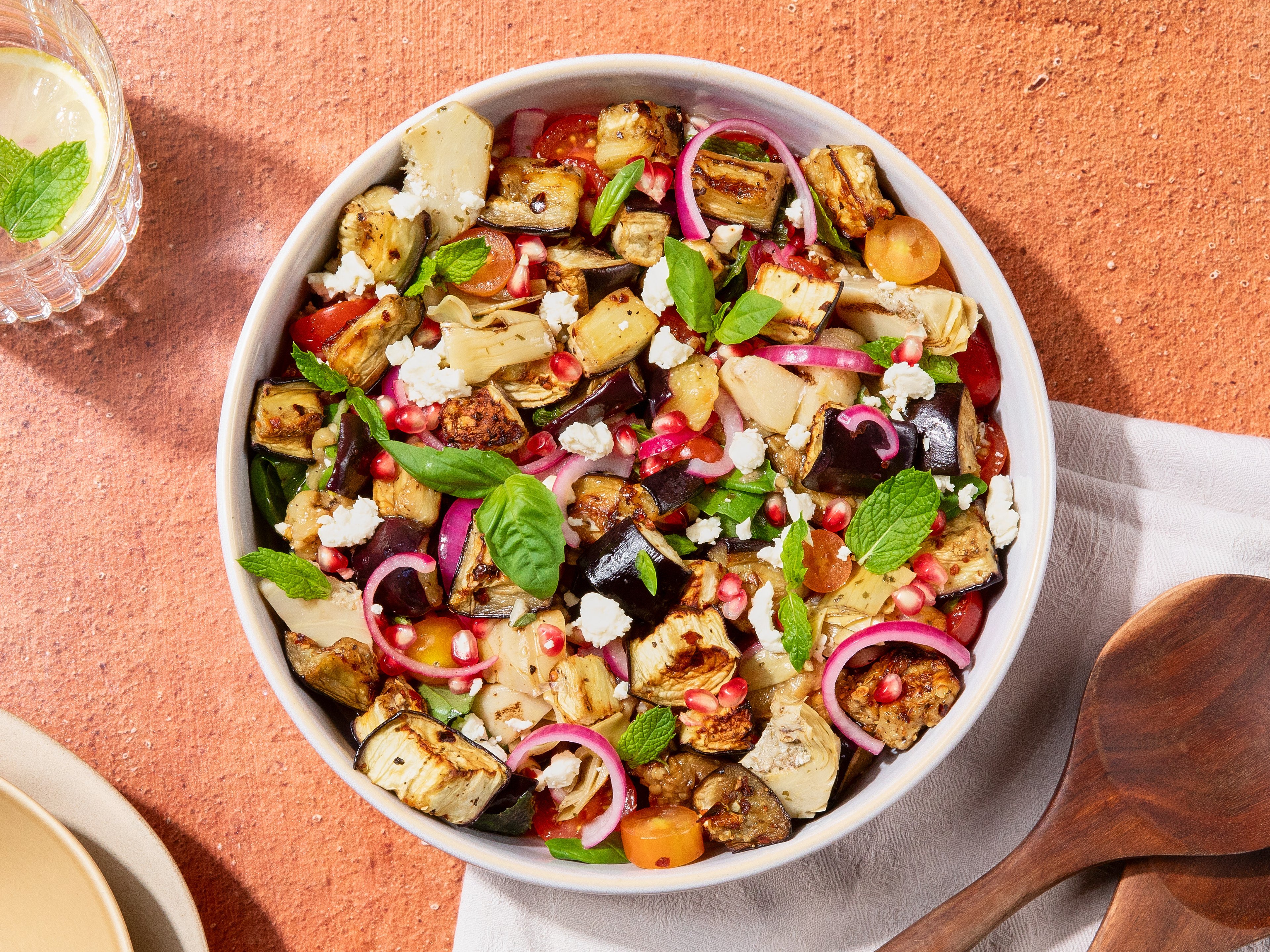 Warm eggplant salad with artichokes and pomegranate