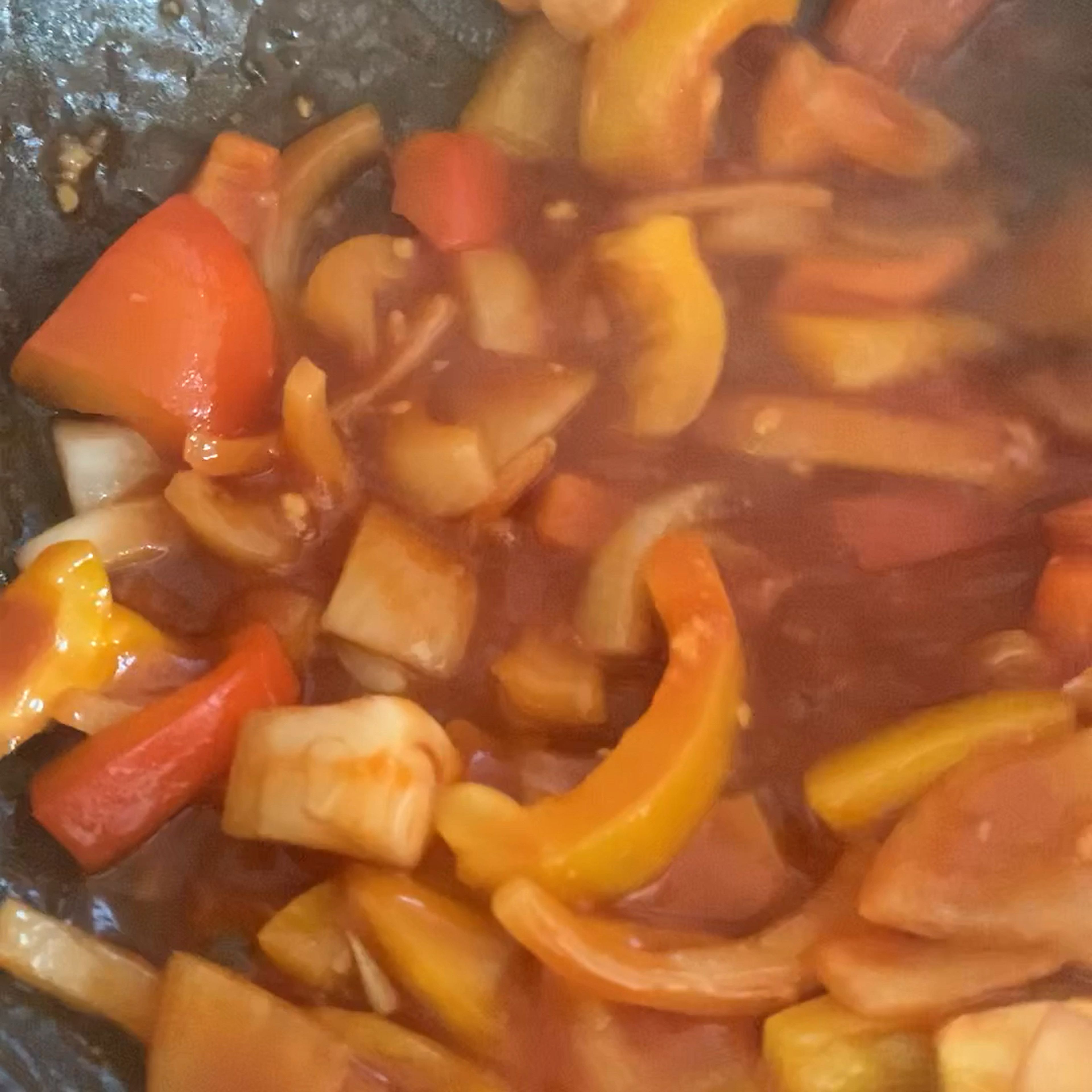 Place a skillet or wok over medium-high heat. Add the 1 tablespoon oil, onion and bell peppers and sauté for 2-4 minutes until slightly softened.