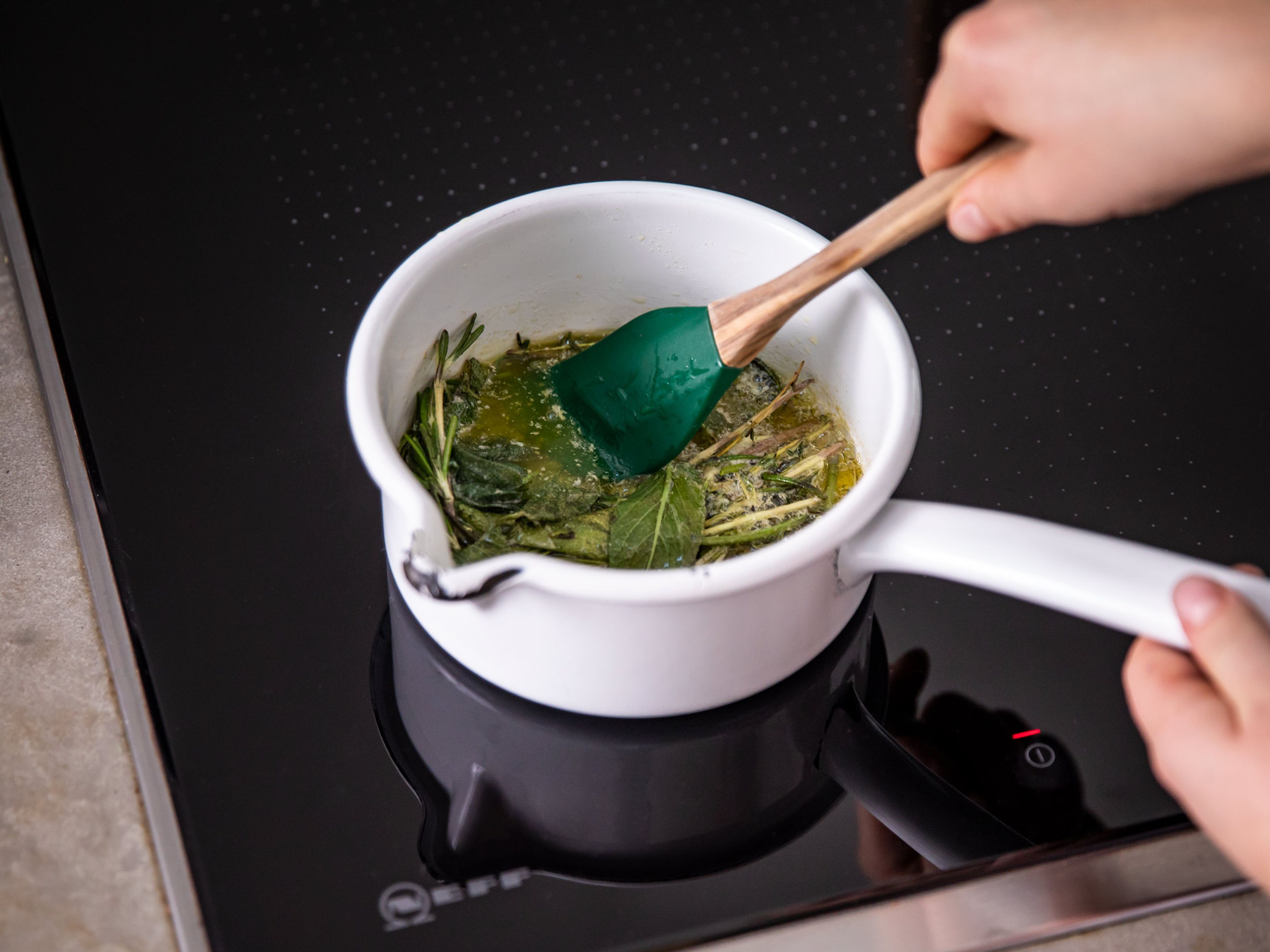 In the meantime, make herb butter by melting butter in a saucepan over low heat. Add remaining rosemary, thyme, and sage, stir and let bubble gently for approx. 2 min. Remove from heat and set aside. Approx. 10 min before the end of the cooking time, baste chicken with melted herb butter.