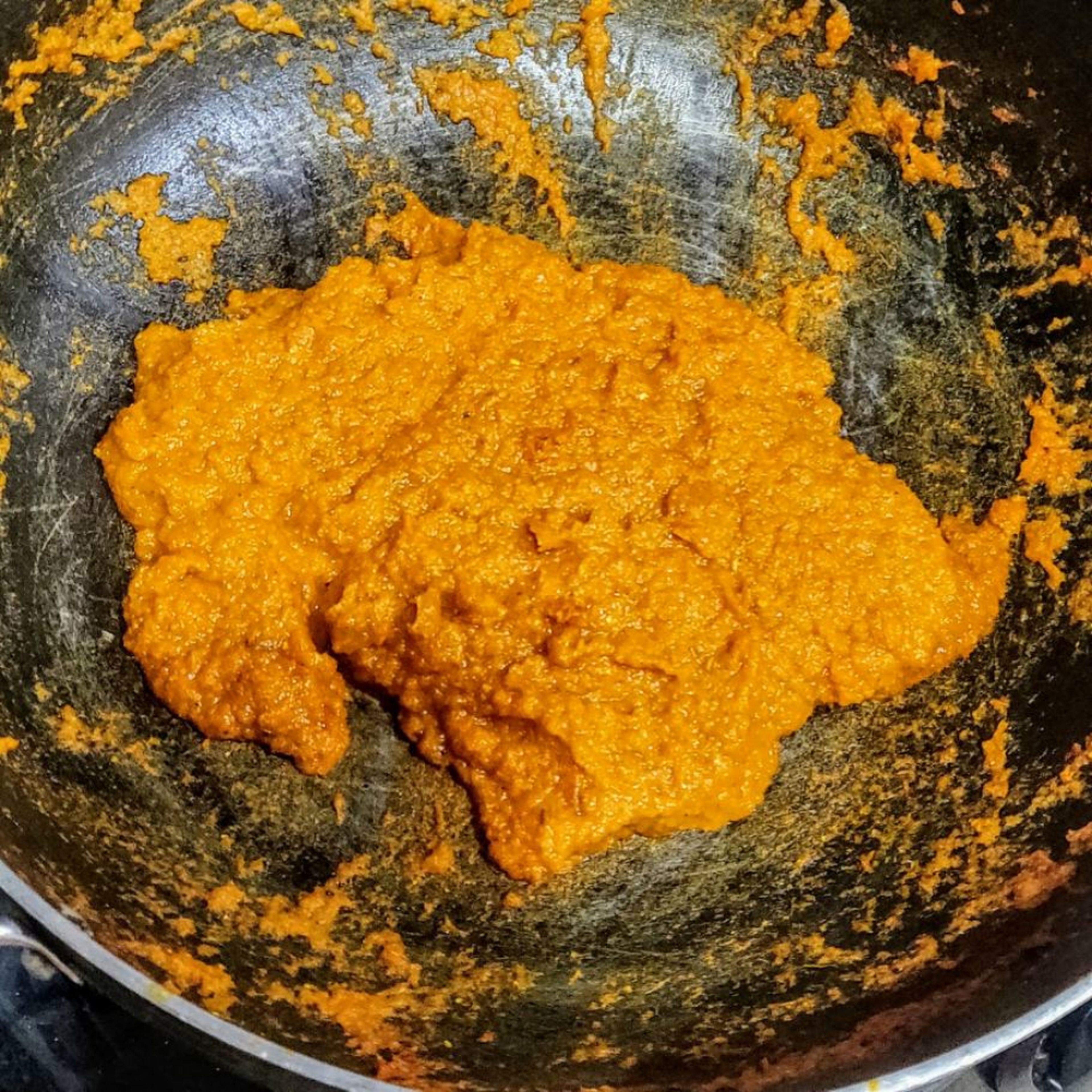 In a wok. Heat oil add 1 TSP red chilli powder. Add the onion tomato paste. Cook it till the oil separates. The paste should look dark red brownish colour. Add 2 tsp coriander powder, 1/2 tsp tumeric powder, 1/2 tsp black pepper powder. This process should take at least 15 min.