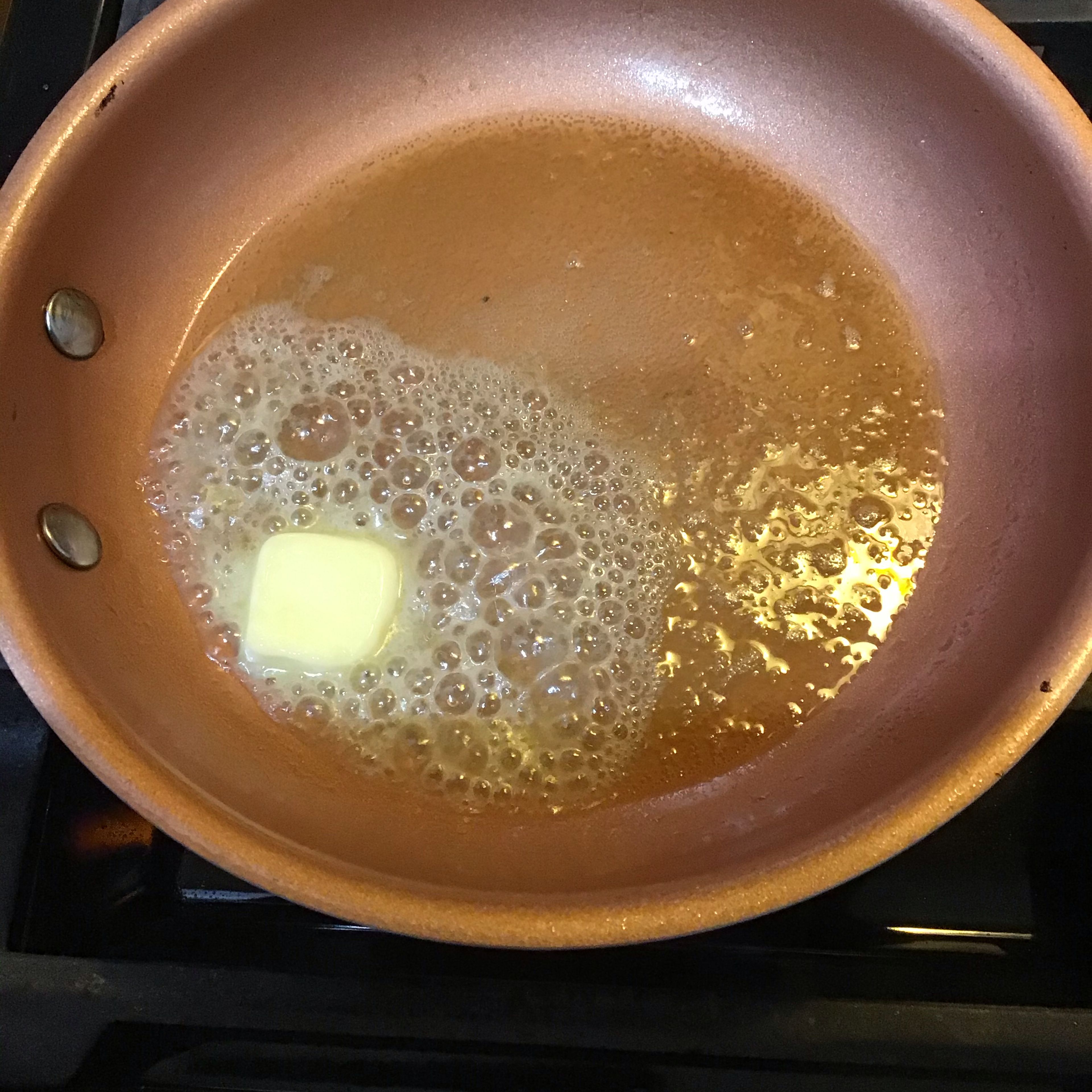 Set a frying pan on medium heat until butter is melted, then turn it to between medium and low setting. 