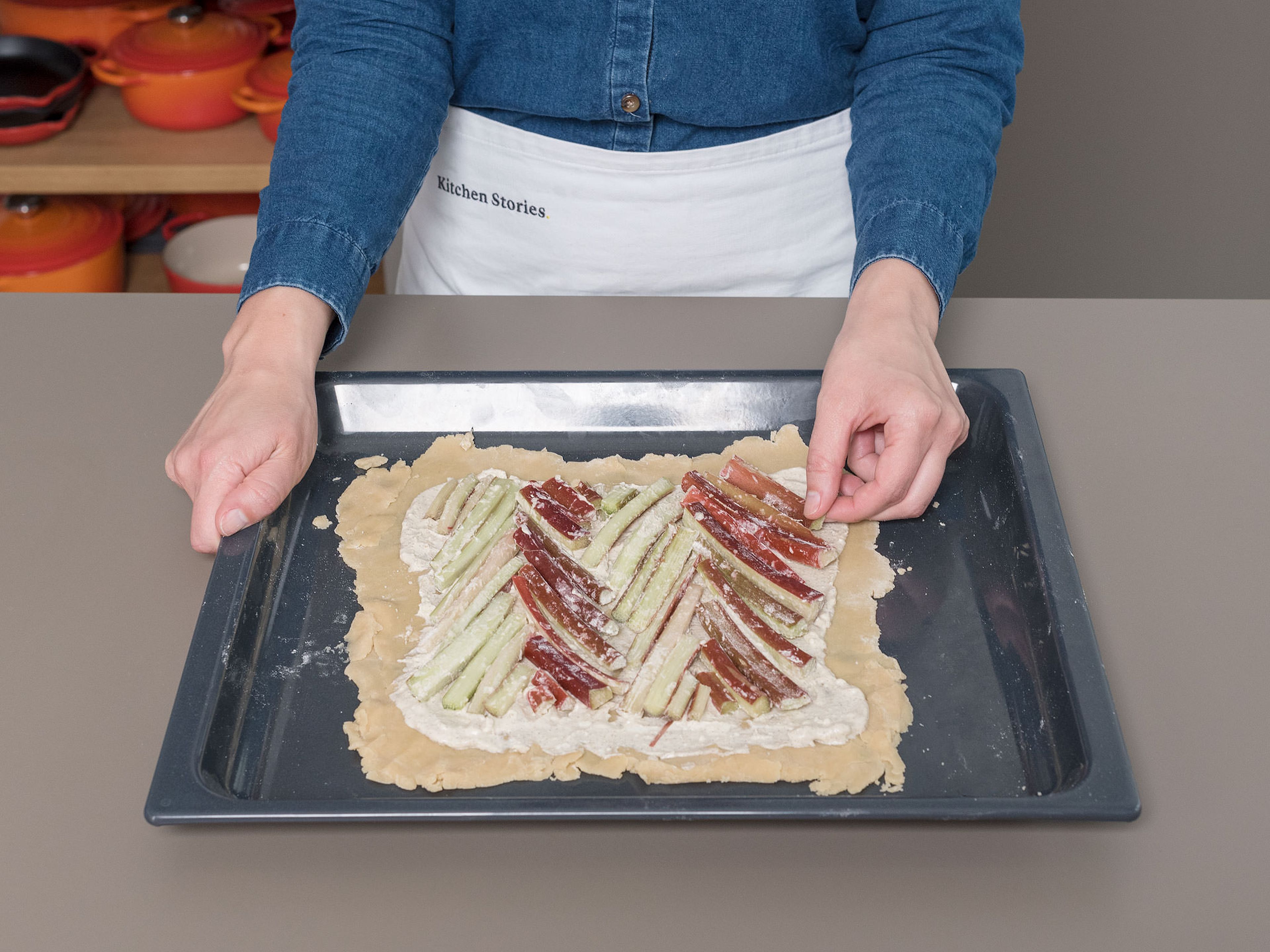 Arrange the rhubarb in a chevron pattern over the mascarpone cheese filling; cut the rhubarb as necessary to fit. Fold the edges of the dough over the rhubarb and crimp. Beat egg yolk into a bowl and brush the dough with it.