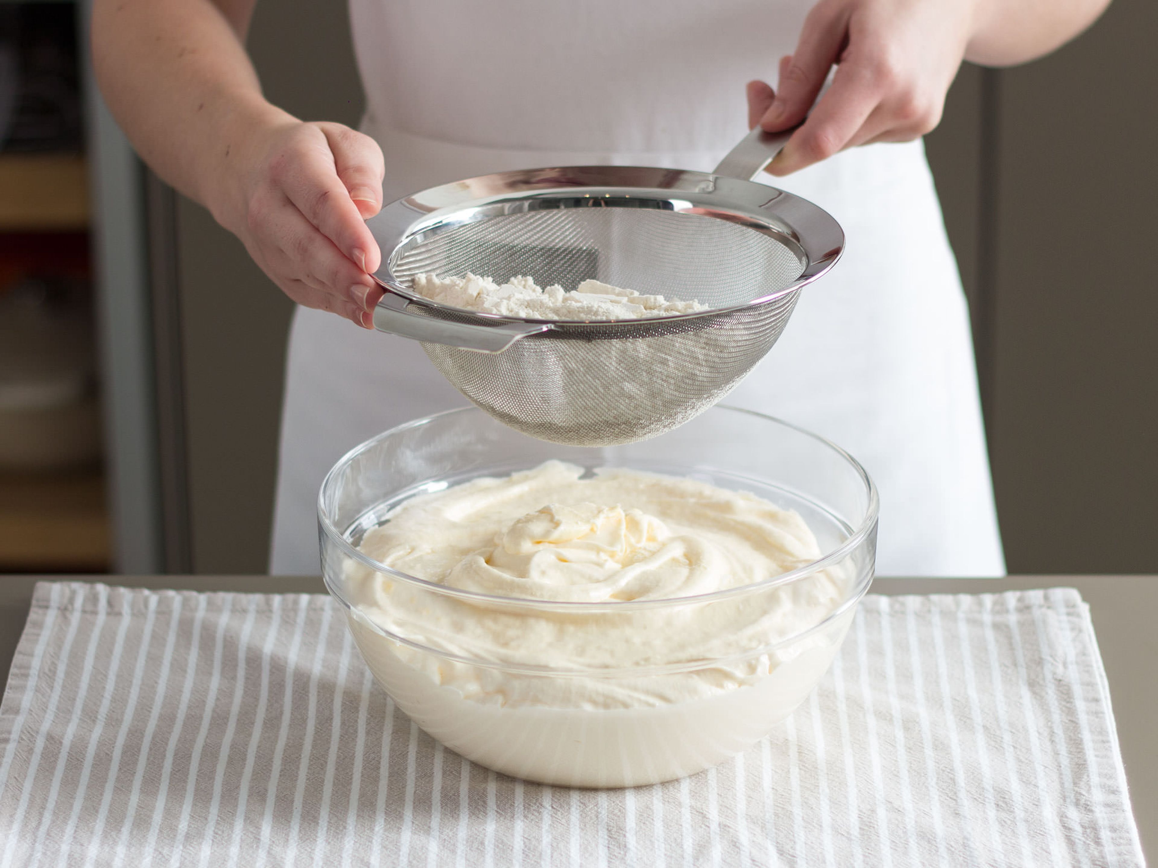 Sift in flour and mix well to combine. In a large bowl, fold egg white mixture into butter mixture. Next, evenly divide batter into two halves, add cocoa powder to one bowl, and mix well to combine.
