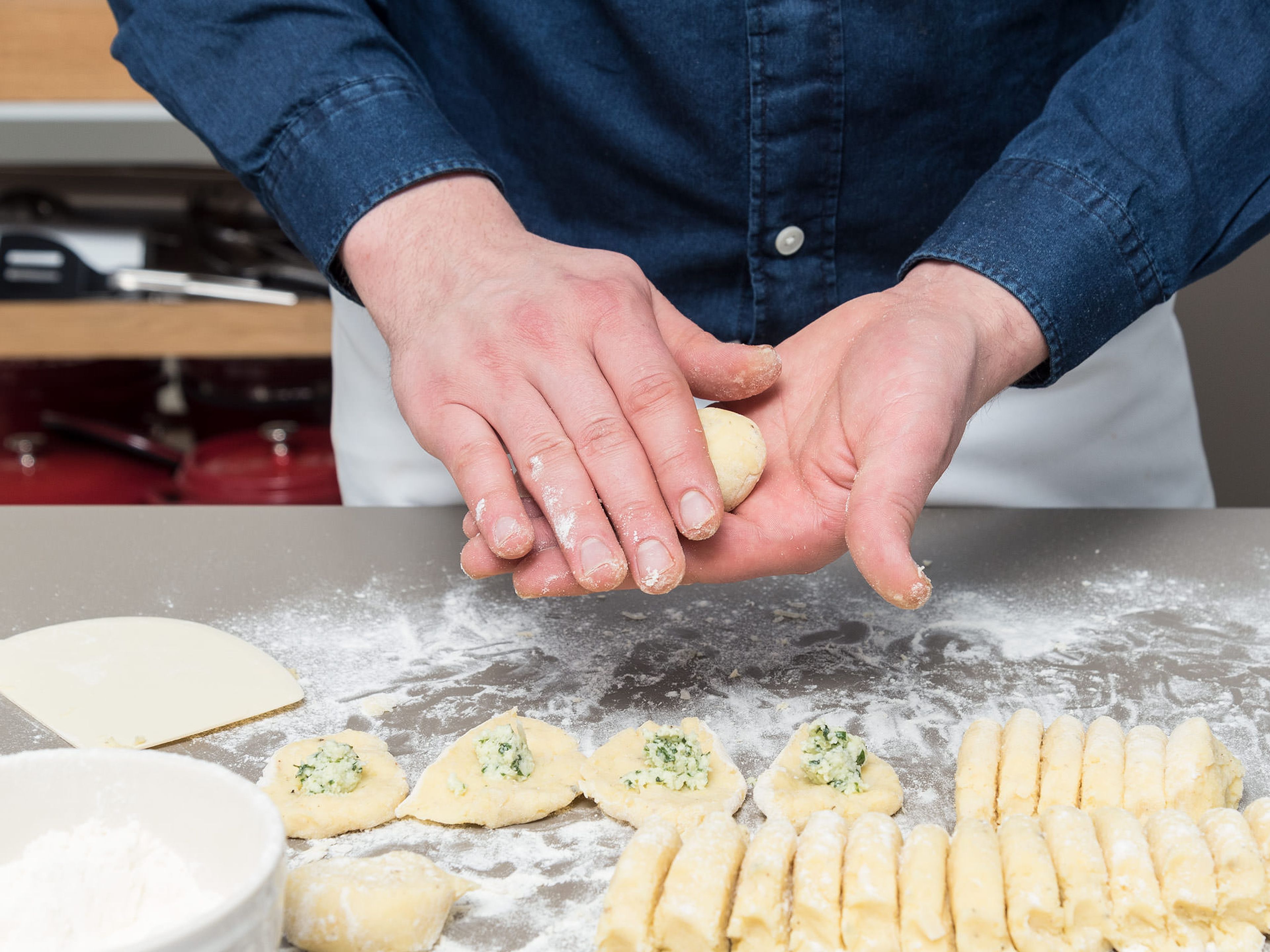 Divide dough in half and roll each half into a log. Cut into even thumb thick pieces. Press lightly to flatten and add a teaspoon of chilled mozzarella filling to each piece. Roll into balls and set aside on a floured surface. Press each gnocchi gently with a fork. When all the gnocchi are filled, cook them immediately in salted, simmering water until they float.