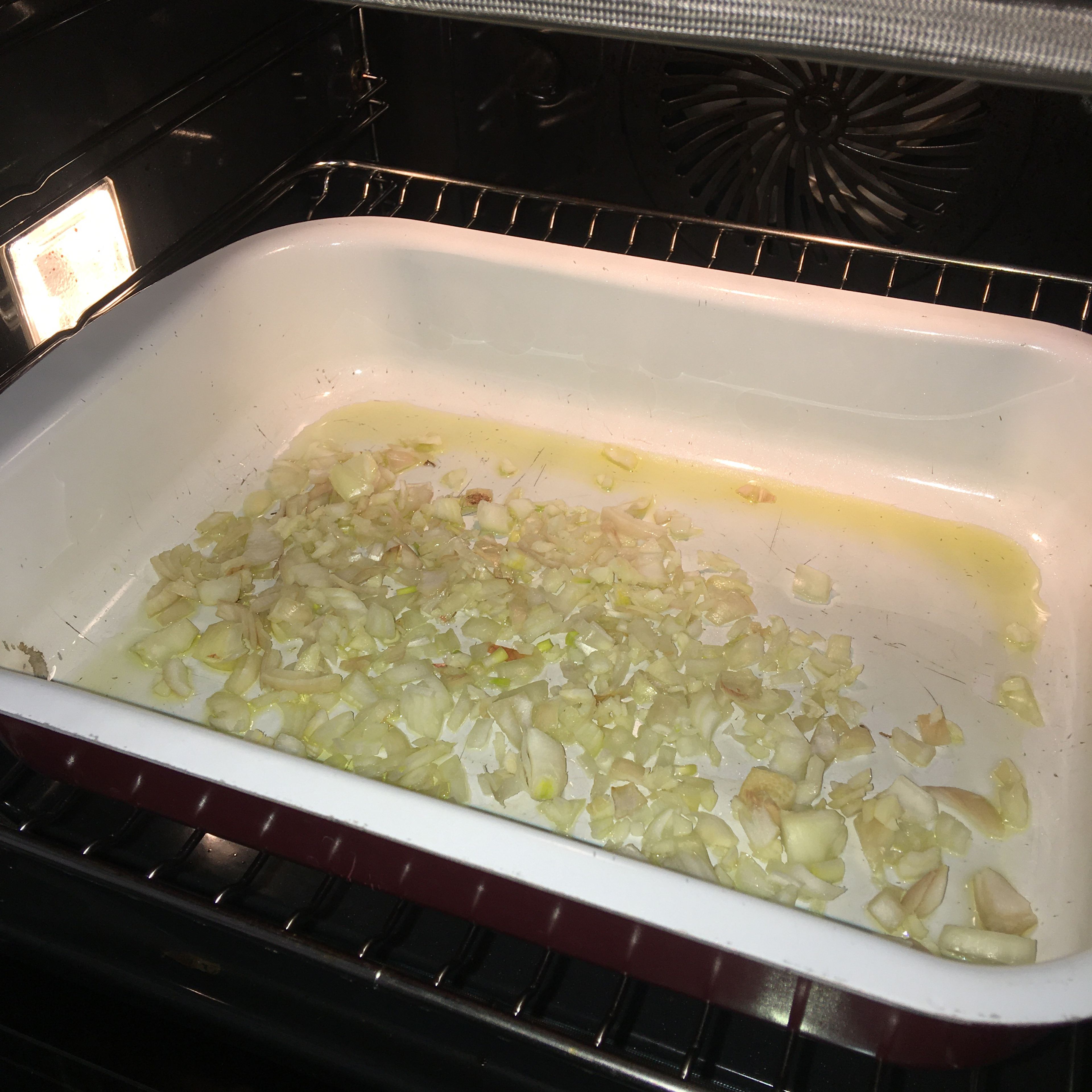 Add olive oil to a deep baking dish or a casserole. Then add the chopped and minced onion and garlic to it. Pop it in the oven for 3-5 mins or until brown and translucent. Be careful not to burn the garlic.