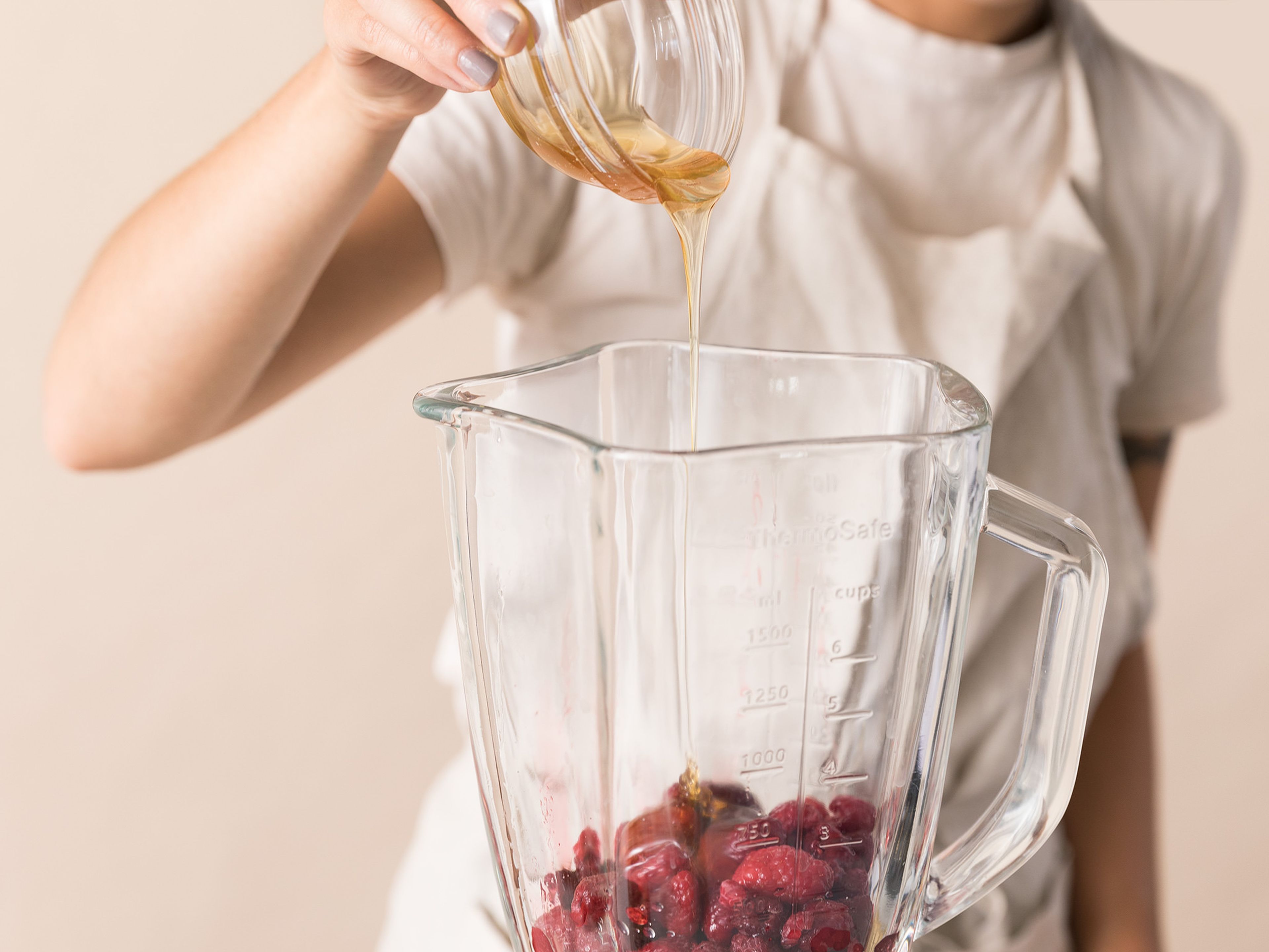 Add mostly thawed raspberries, lemon juice, and honey to a blender. Blend to combine. Add to a loaf pan and freeze for approx. 90 min. or until semi-solid. Scoop, top with lemon zest, and enjoy!