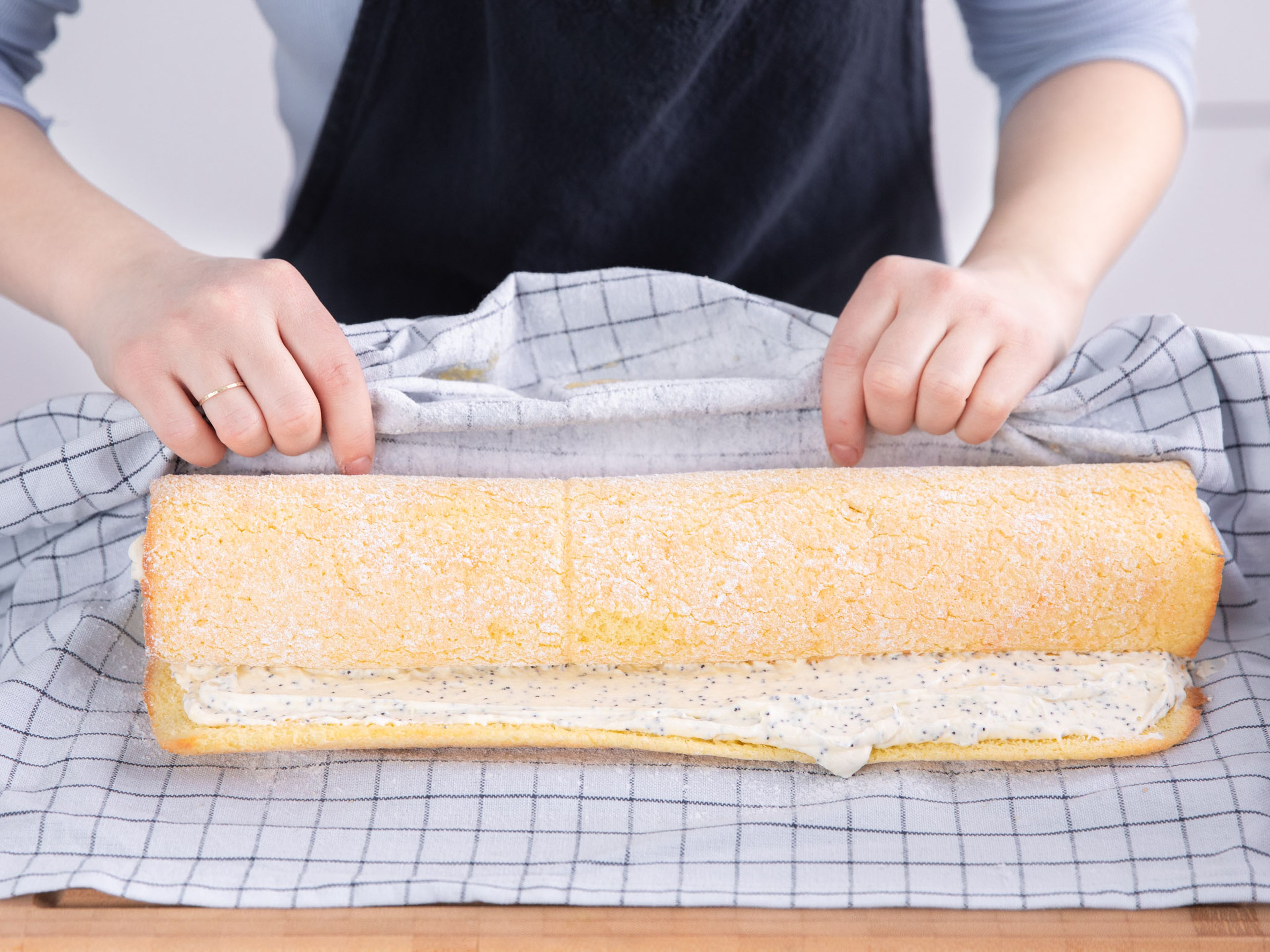 Once cake and filling are cooled, unroll cake and spread lemon and poppy seed filling over the cake. Carefully roll up the cake and wrap in plastic wrap. Refrigerate for approx. 1 hr. Dust with more confectioner’s sugar before serving, slice, and garnish with lemon zest and fresh mint. Enjoy!