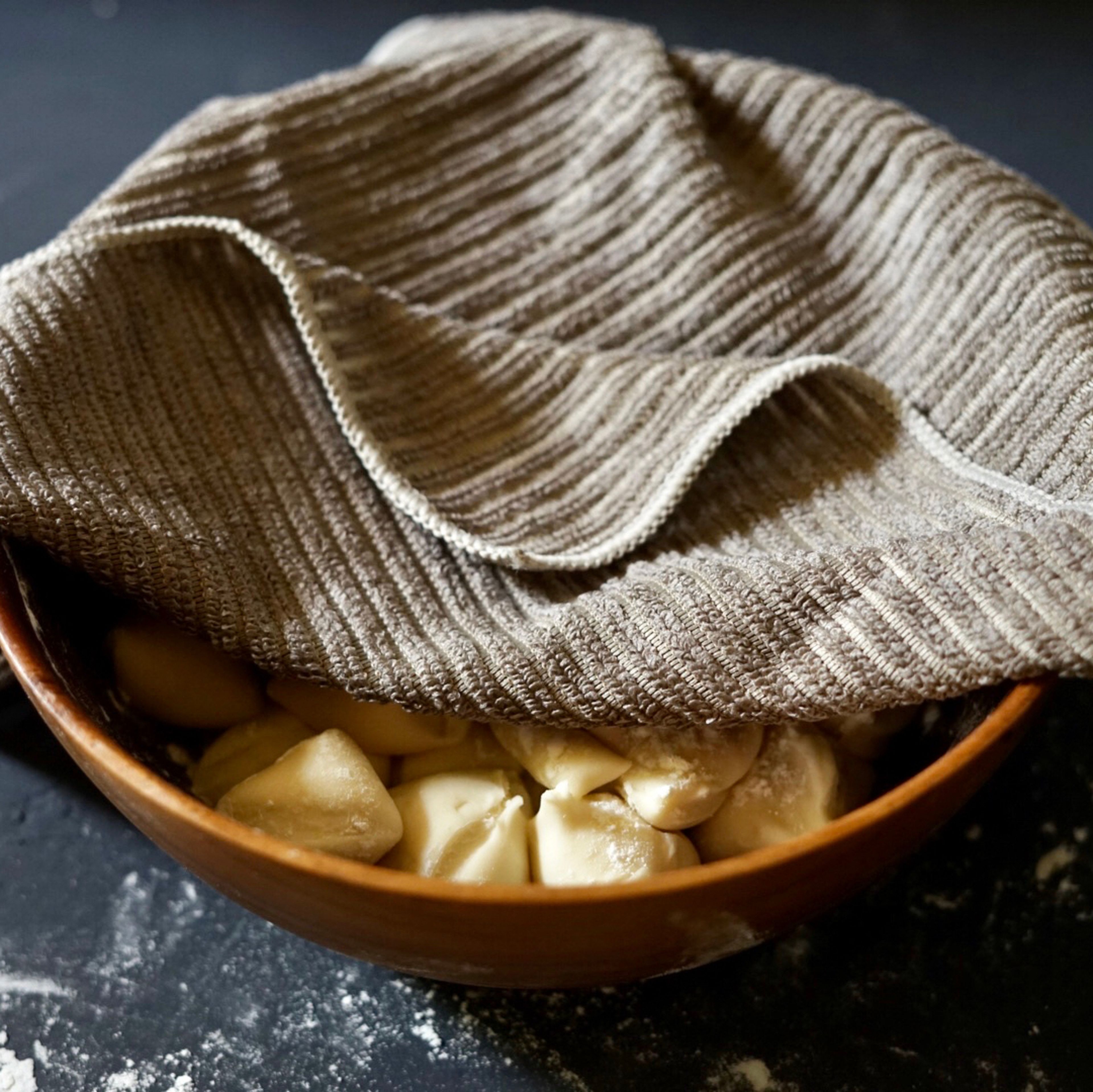 Place the dough pieces in a big bowl and cover them to prevent them from drying out when you’re working.