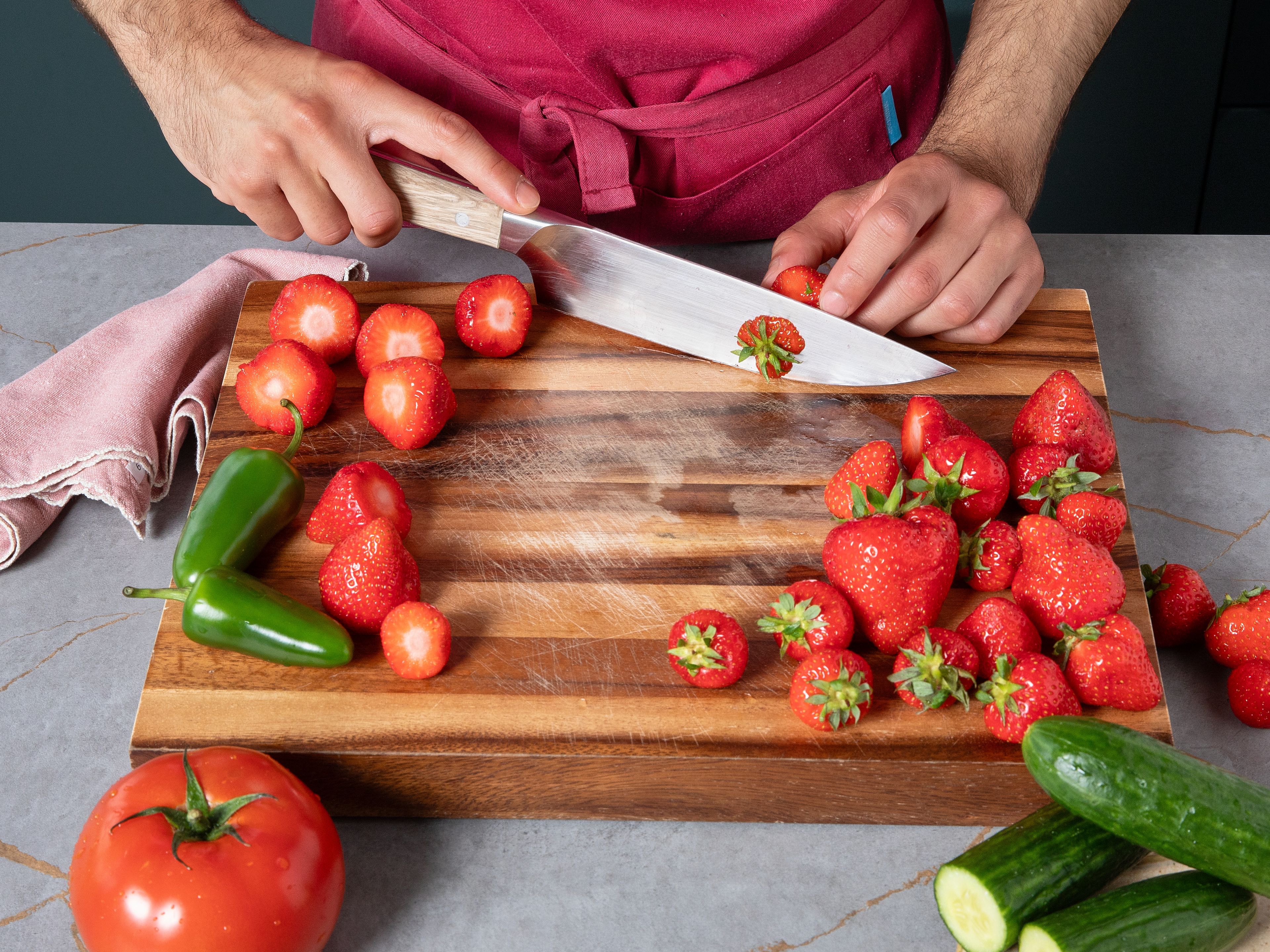 Cut stems off strawberries. Roughly chop tomato and cucumber. Cut jalapeño into thin rings and set some aside for garnish. Put some mint aside for garnish as well.
