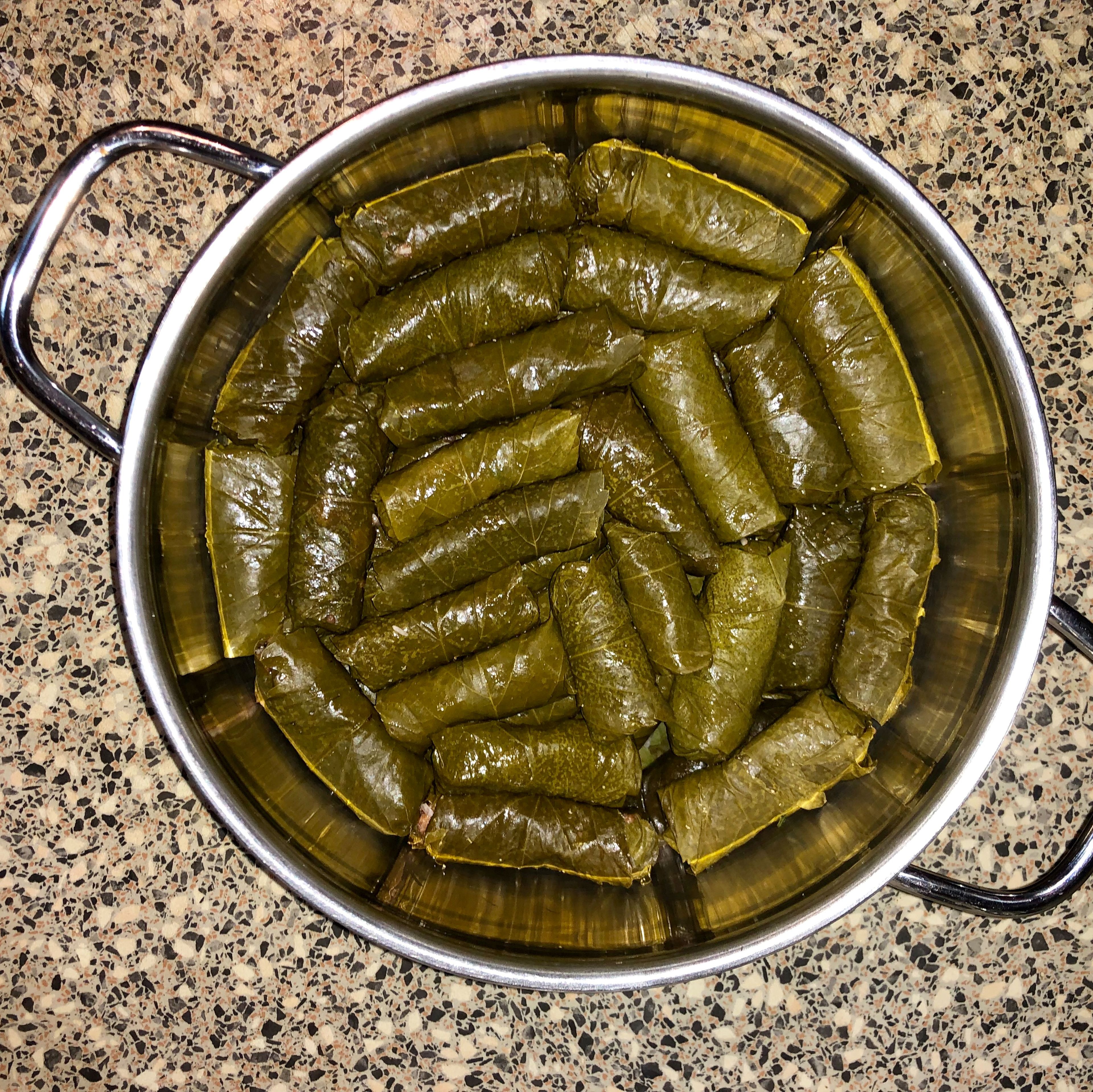 Place the rolled dolma in the pot.  Layer the dolma in two or three layers.
