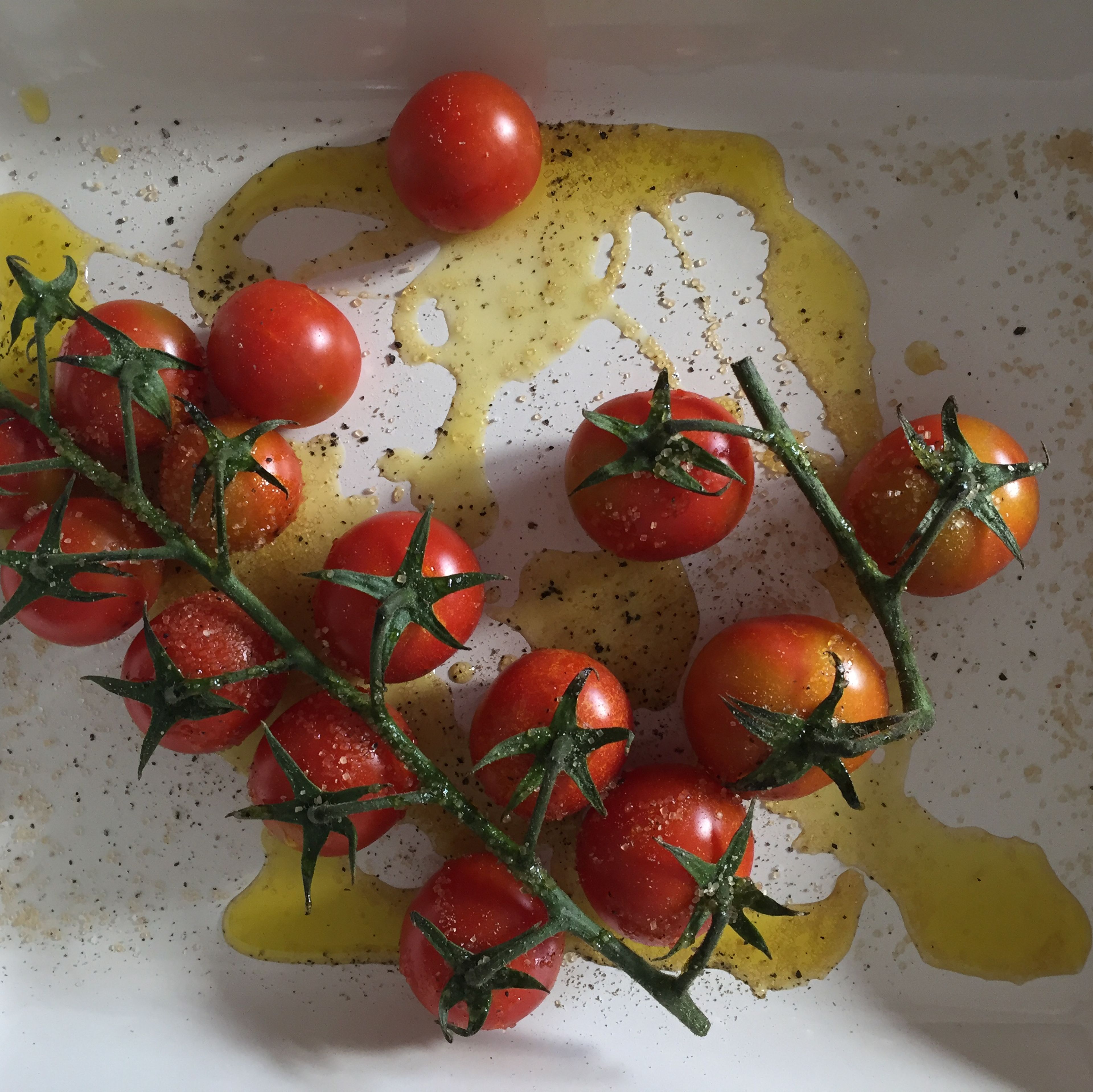 Mix tomatoes in a baking dish with 8 tbsp oil, sugar, salt, and pepper. Bake in the oven at 175°C/350°F for 20 min.
