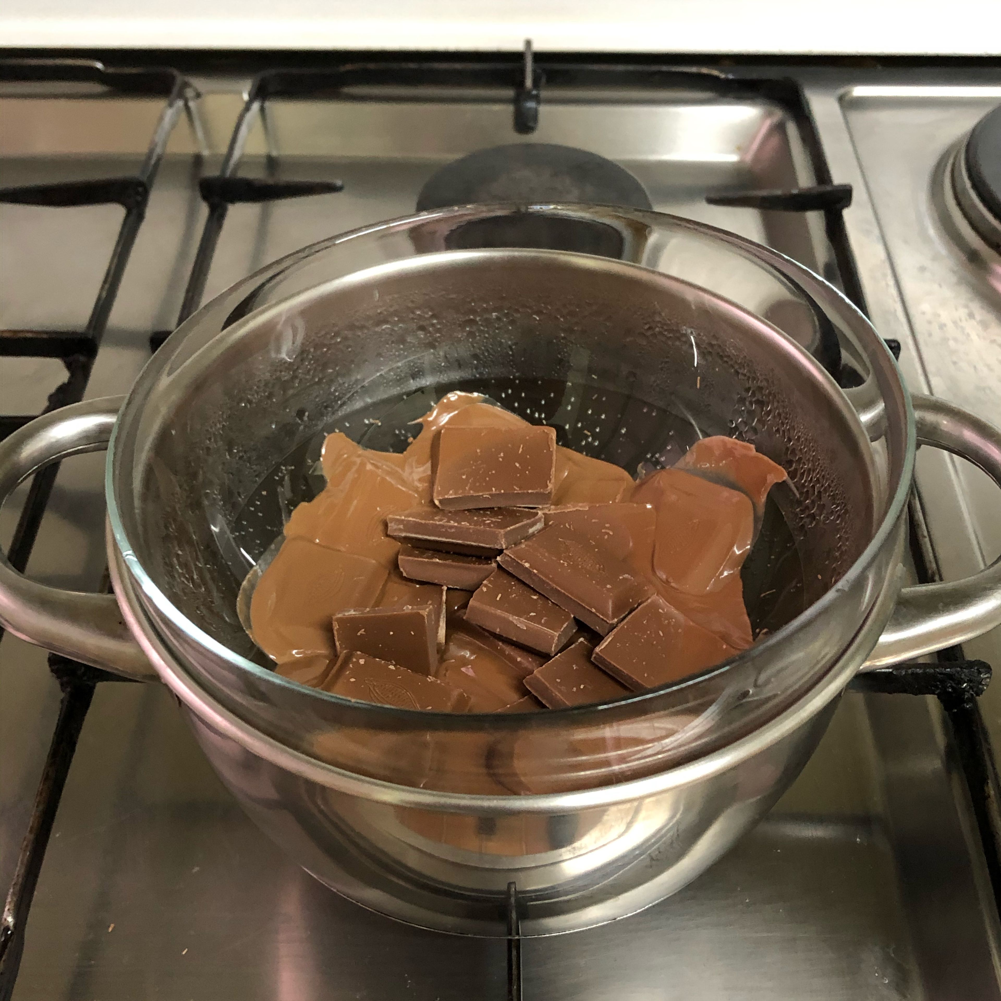 Grab a small pot and fill it with water, half way. Set the stove at medium low heat. Set a bowl on top of it and add your chocolate so it melts properly.
