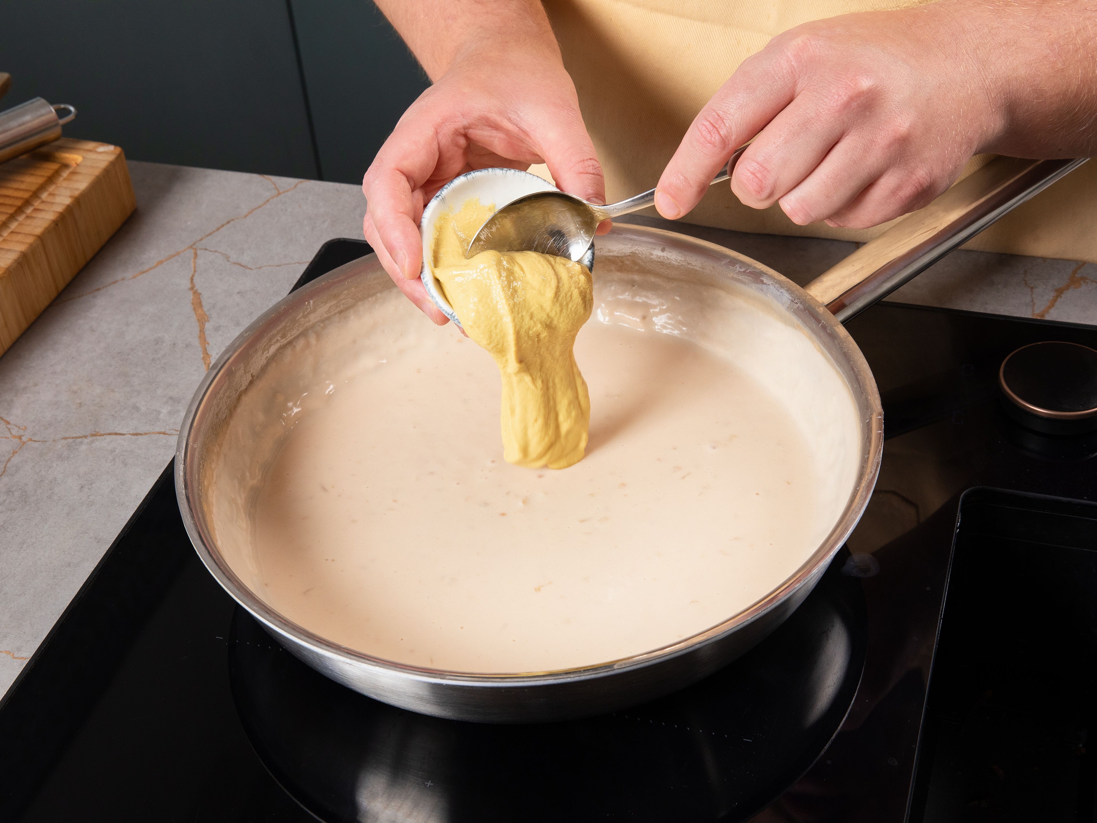 Stir in mustard, vinegar, and sugar to the sauce. Bring mustard sauce to a boil once more. Season generously with salt. Finely chop parsley.