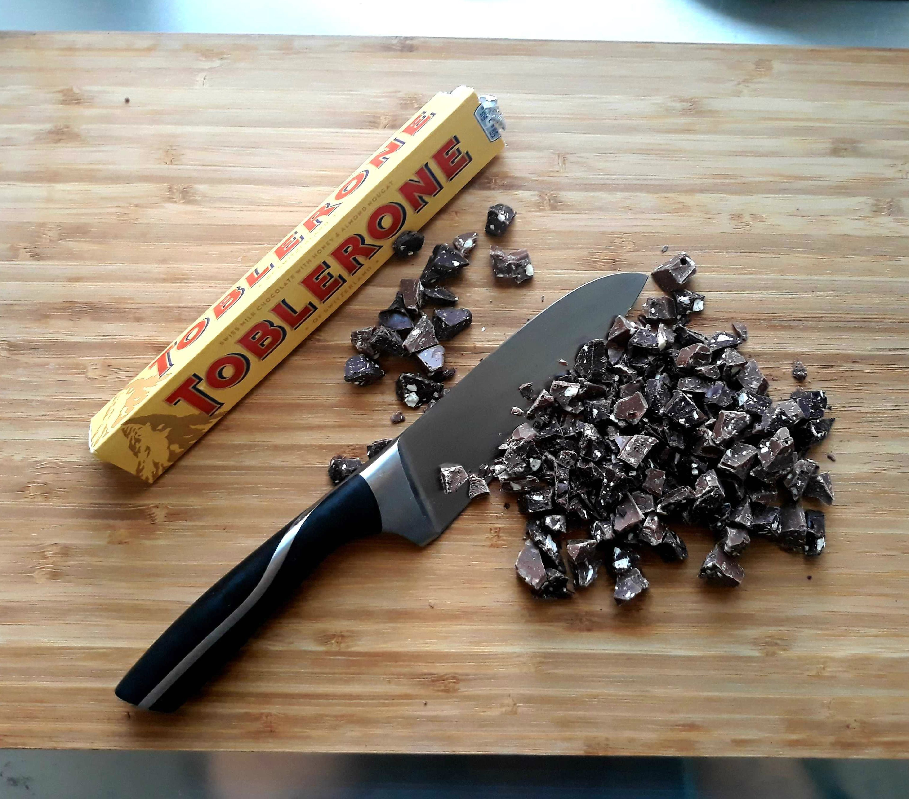 Roughly chop "Toblerone" or any chocolate of your choice. Fold the choppped chocolate into the dough. Preheat oven to 190°C/375°F.