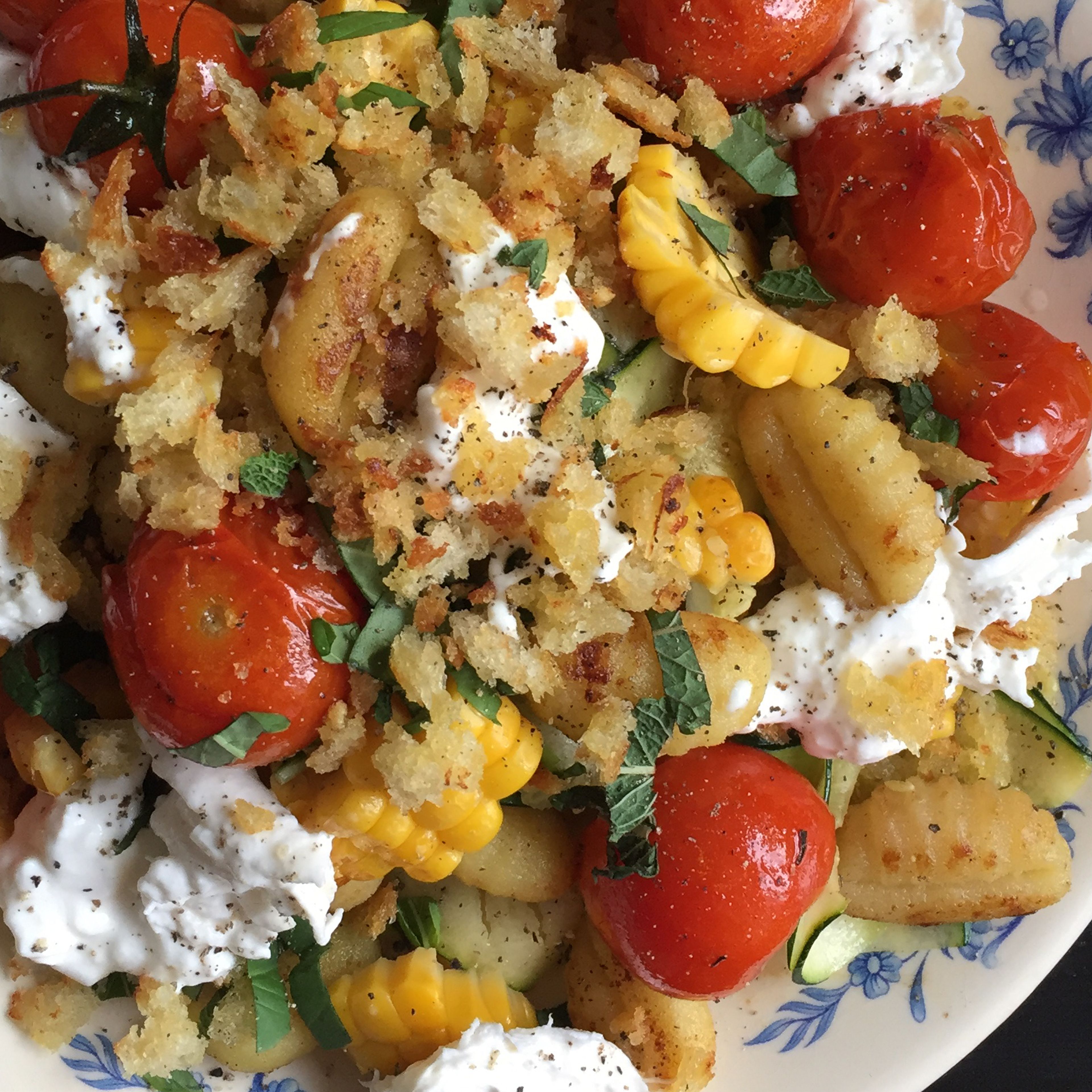 Serve gnocchi with zucchini, corn, oven tomatoes (with the oil), breadcrumbs, herbs, and burrata cheese. Season with lemon juice, salt, and pepper to taste.