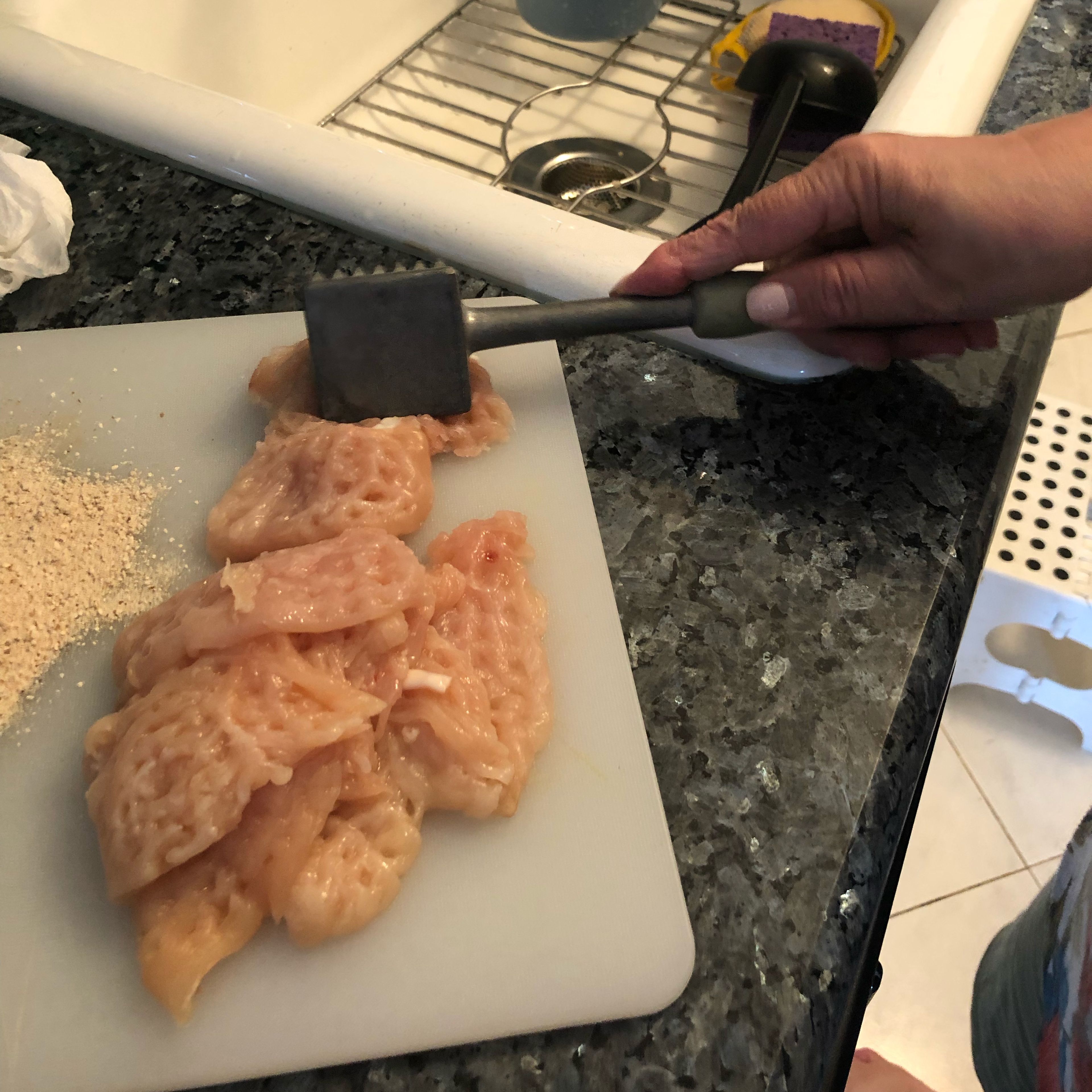 First wash the breasts and dry it with a paper towel. Then take a meat mallet and beat the chicken breasts on both sides. Beat until soft and thin
