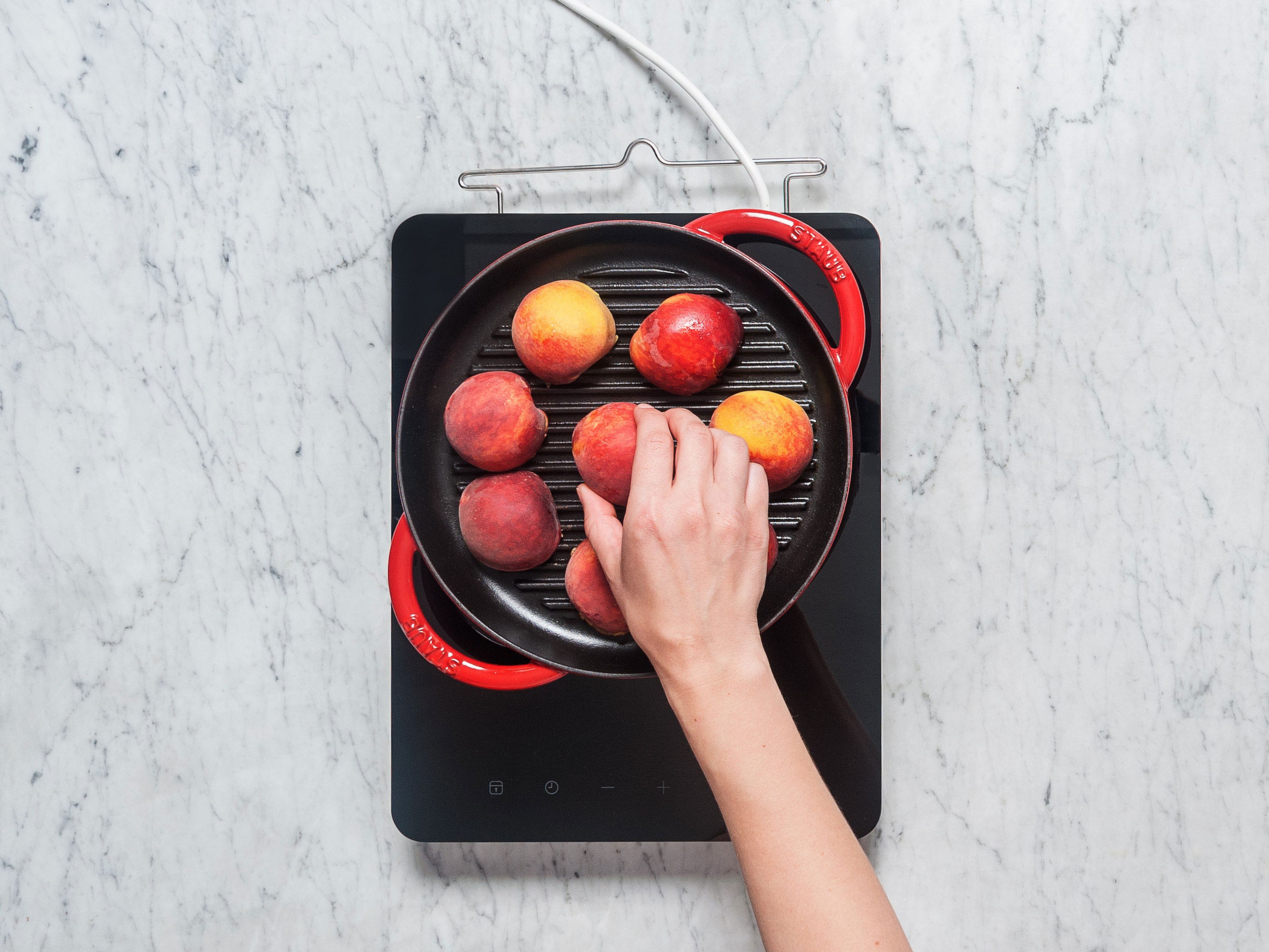 Heat the grill pan over high heat. Grease the pan with some oil if needed. Place the peaches cut side-down into the pan and grill for approx. 3 – 5 min, or until grill marks have formed.