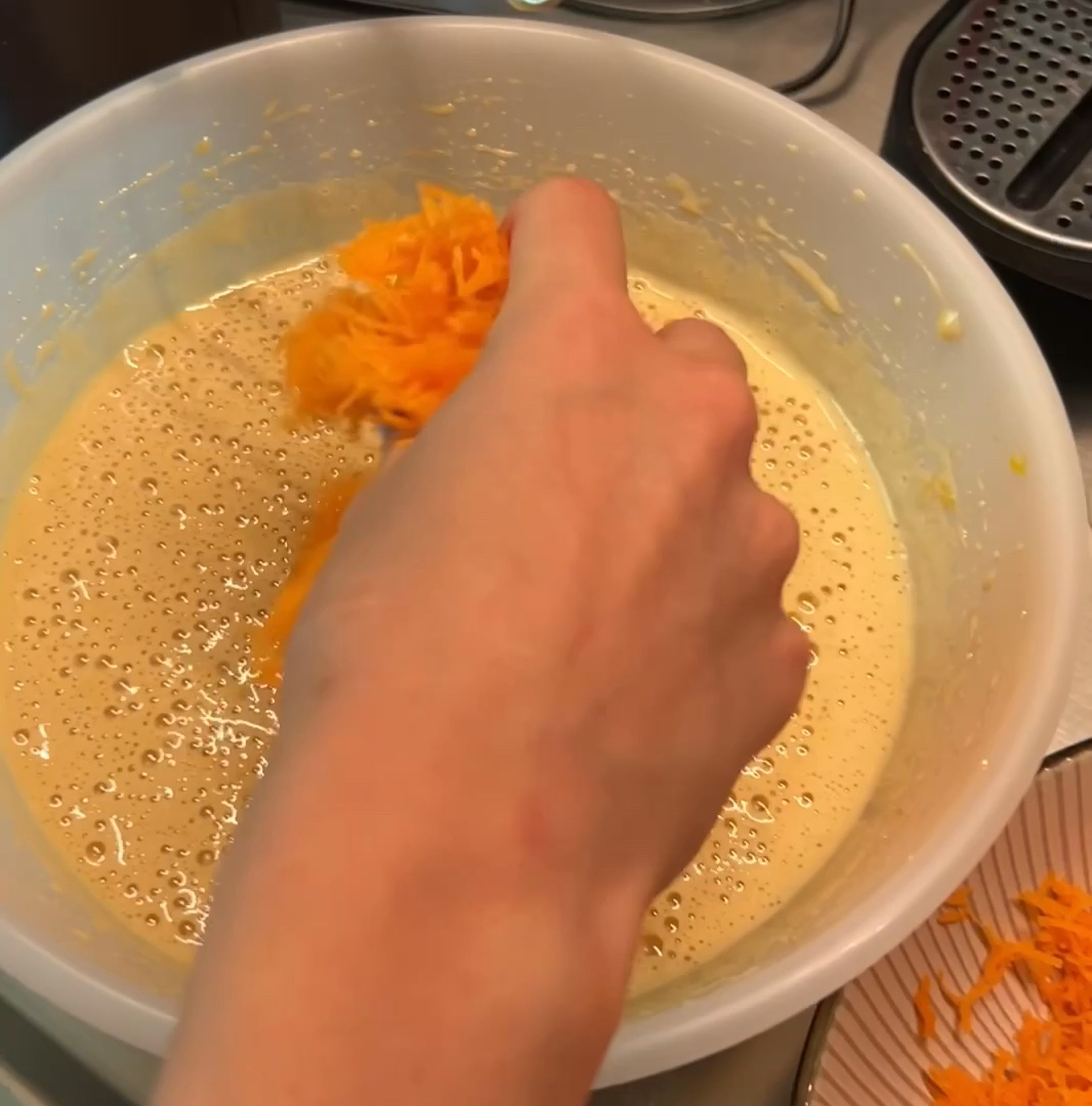 Add shredded carrots, raisins, zest from one lemon and lemon juice to a bowl with wet ingredients and mix until combined. 