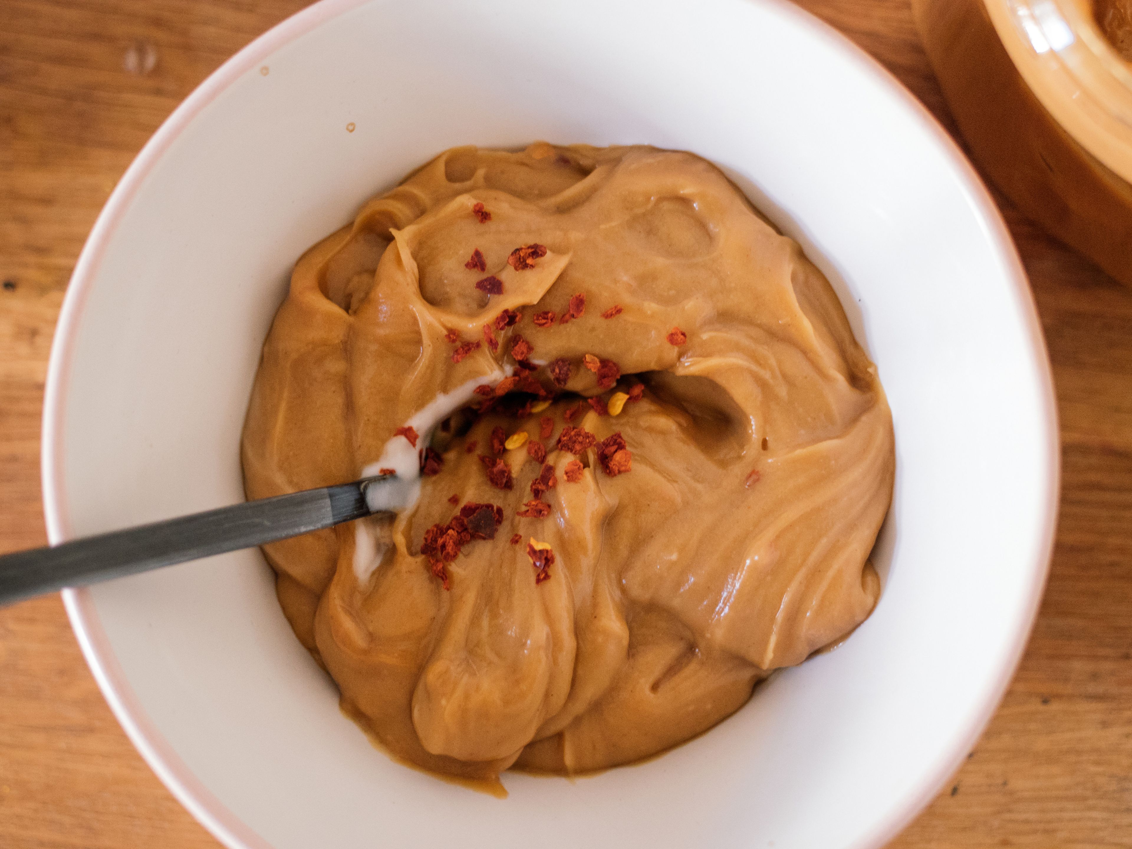 For the peanut sauce,, add creamy peanut butter, coconut milk, soy sauce, maple syrup, and lime juice to a bowl. Stir to combine and if desired, add some chili flakes to taste.