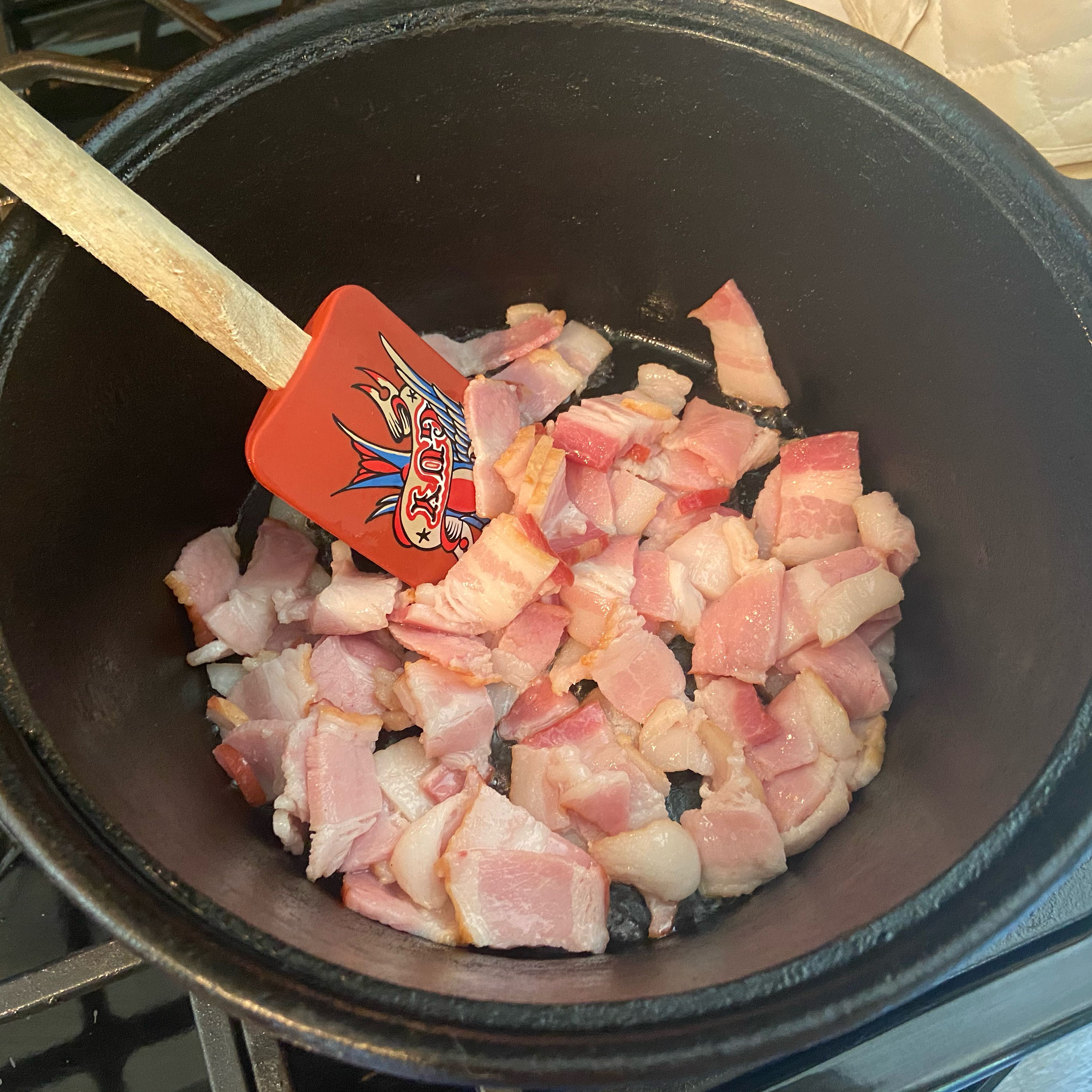 Cut the bacon into half inch chunks and then brown in a heavy bottomed pan, I like using my cast-iron Dutch oven.￼ we recently returned from a mini vacation to Alabama where I picked up bacon and several packages of smoked sausage from Conecuh Sausage Co. And I’m using half of the bacon in this recipe so it’s my first time trying it but you can use whatever your favorite baking is.￼￼
