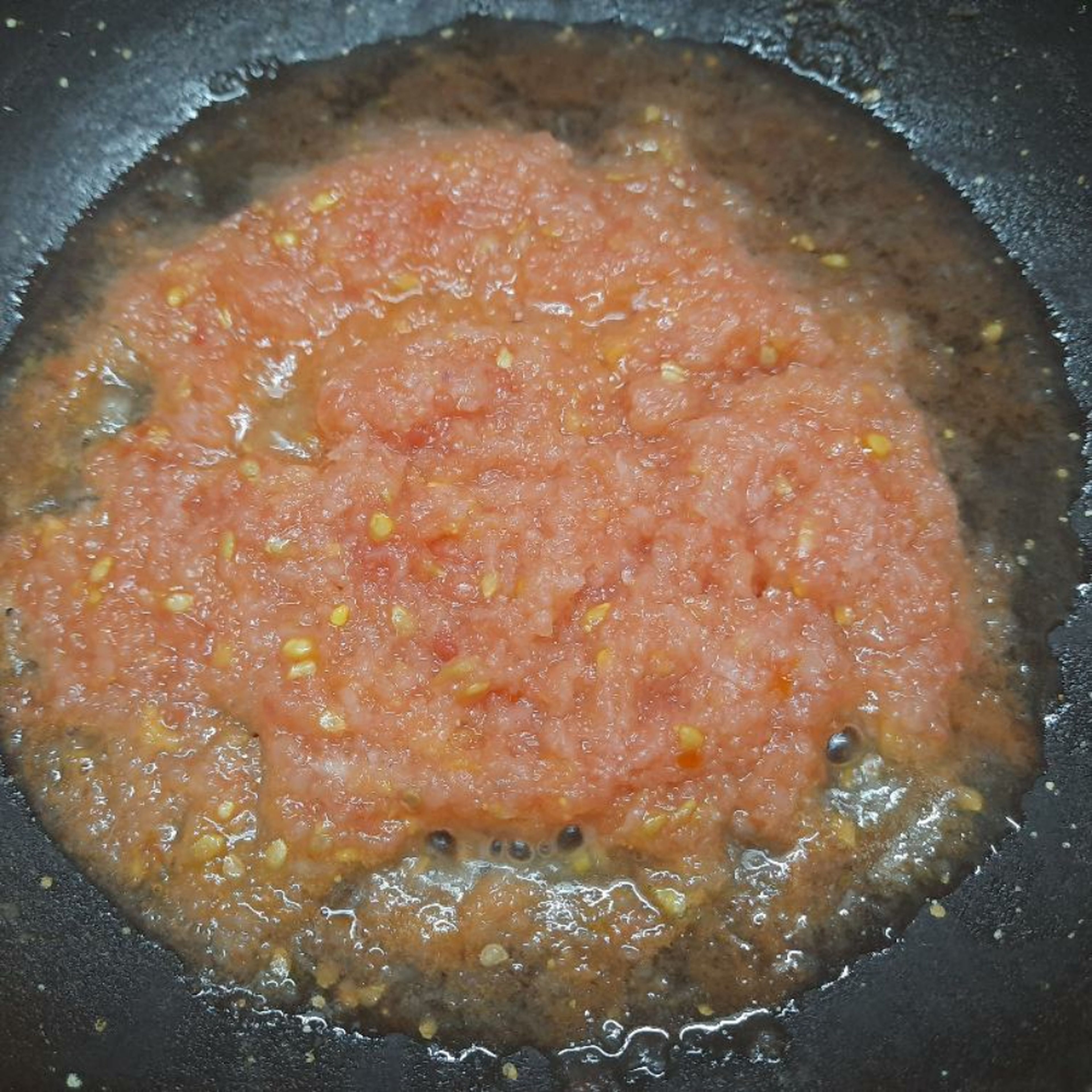 Take a pan. Add 3tsp of oil. Heat on low flame for 2mins. Add onion puree and stir for 2mins. Add tomato puree. Mix well and stir for 2mins. You should see water leaving from sides.