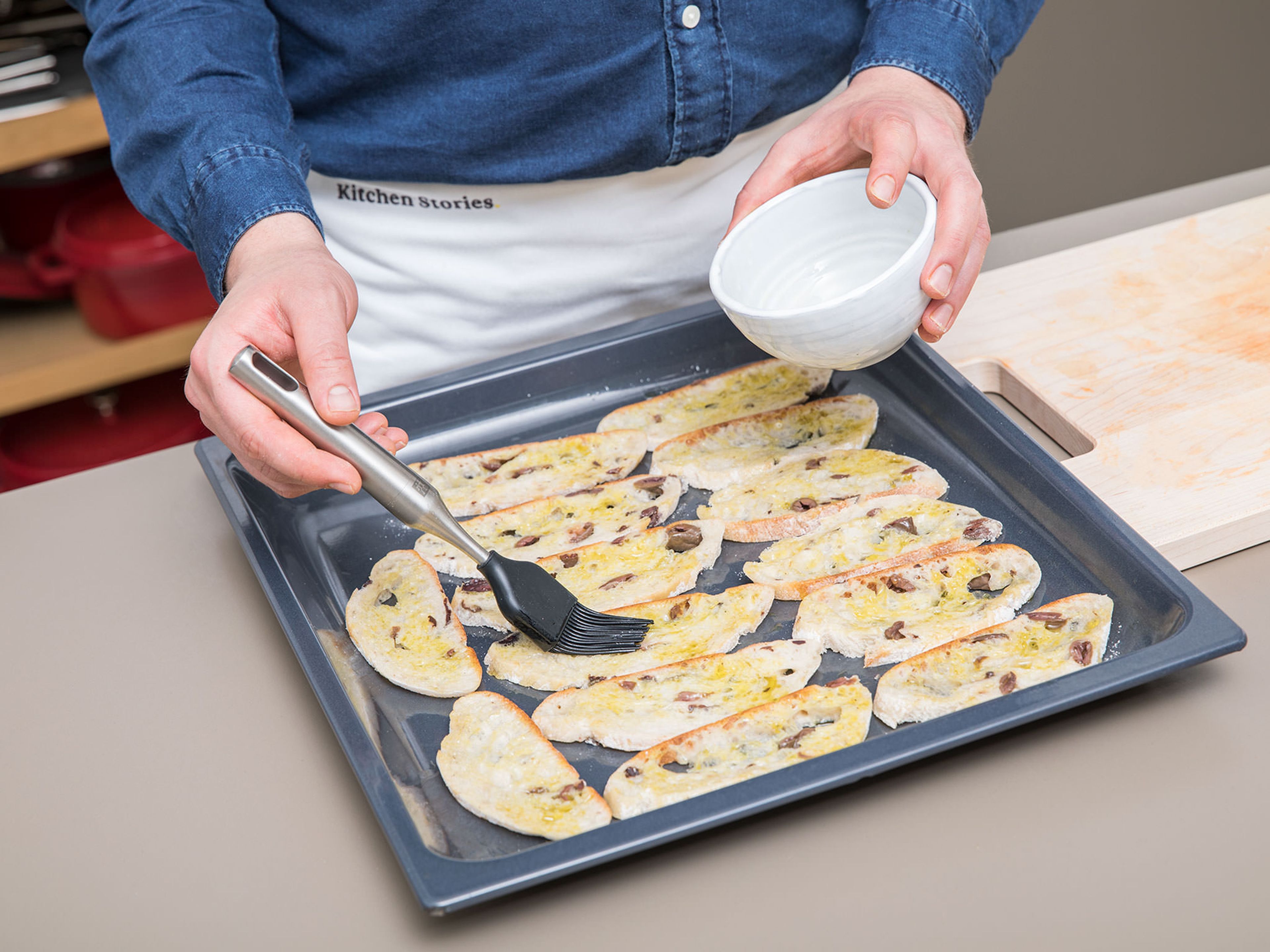 Slice ciabatta bread into thin slices and place on a parchment-lined baking sheet. Brush each side with remaining olive oil and bake for approximately 10 min. at 180°C/350°F or until golden brown and crunchy.