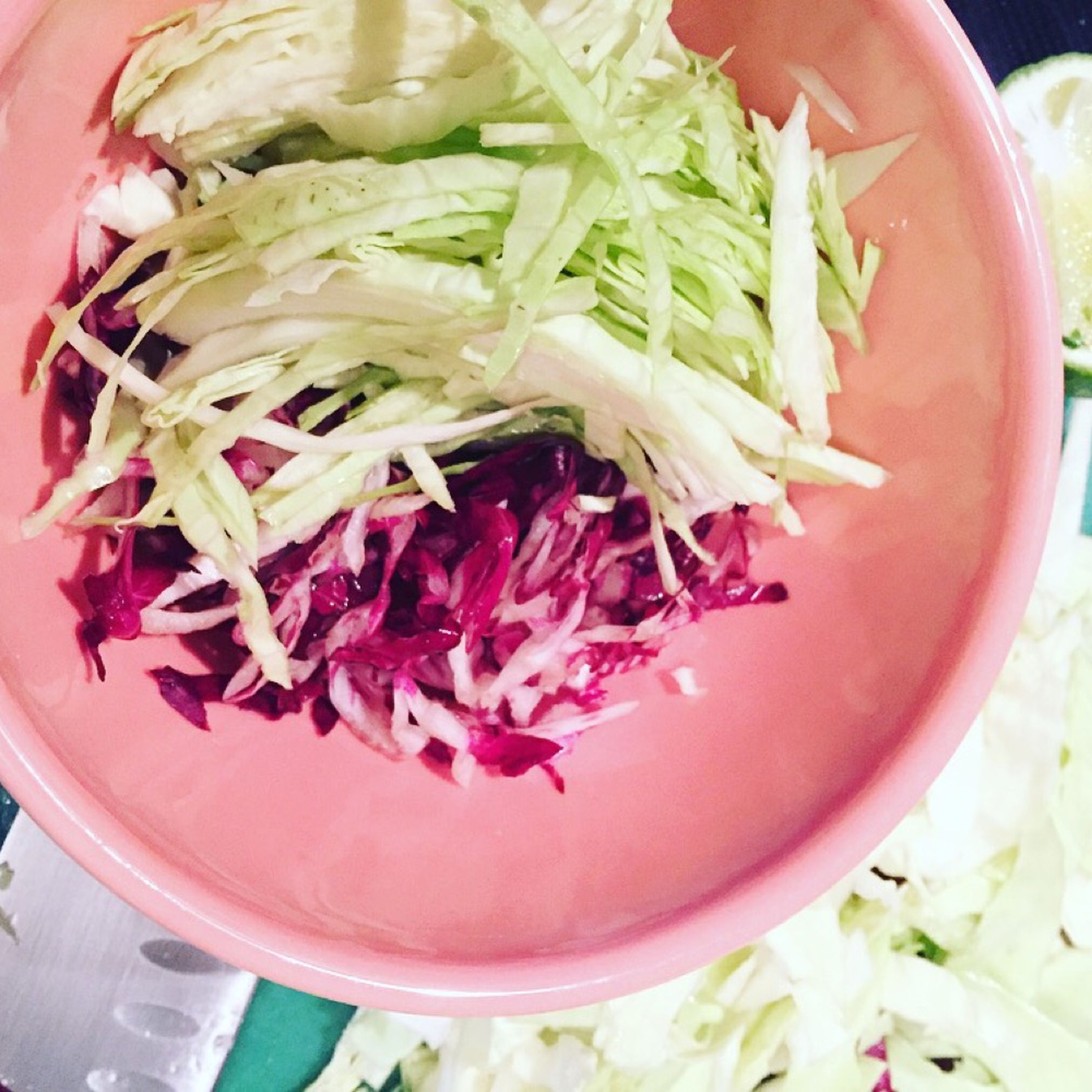 Thinly slice cabbage and radicchio and add to a bowl. Add apple cider vinegar, tossing to combine, and set aside.