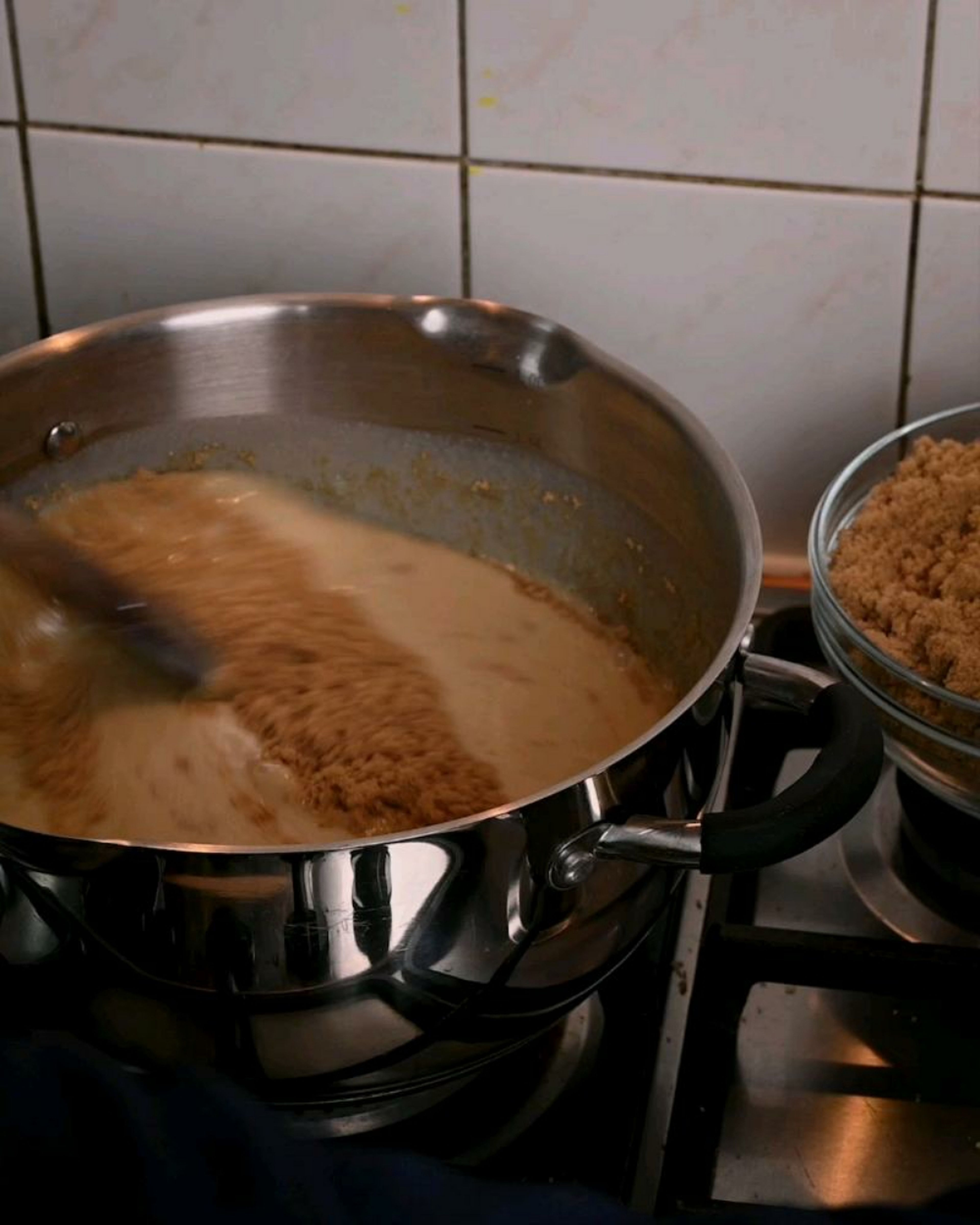 Gradually add tablespoons of sugar and mix well to dissolve the sugar with the condensed milk.