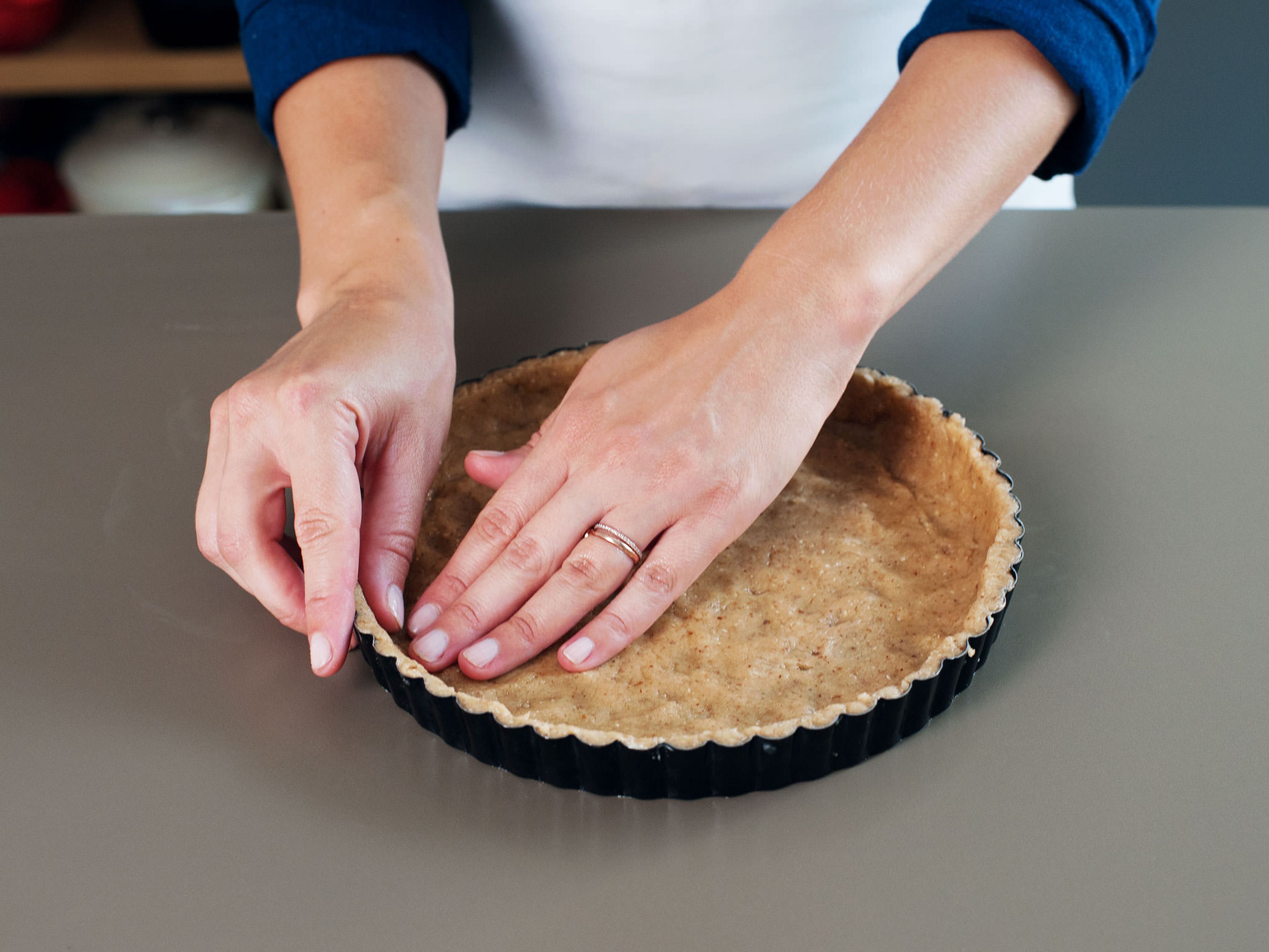 Turn dough out onto a lightly floured surface and knead a couple of times until the dough is smooth. Reserve a third of the dough for the topping and press the remaining dough evenly into tart pan, making sure to press it up the sides and into corners.