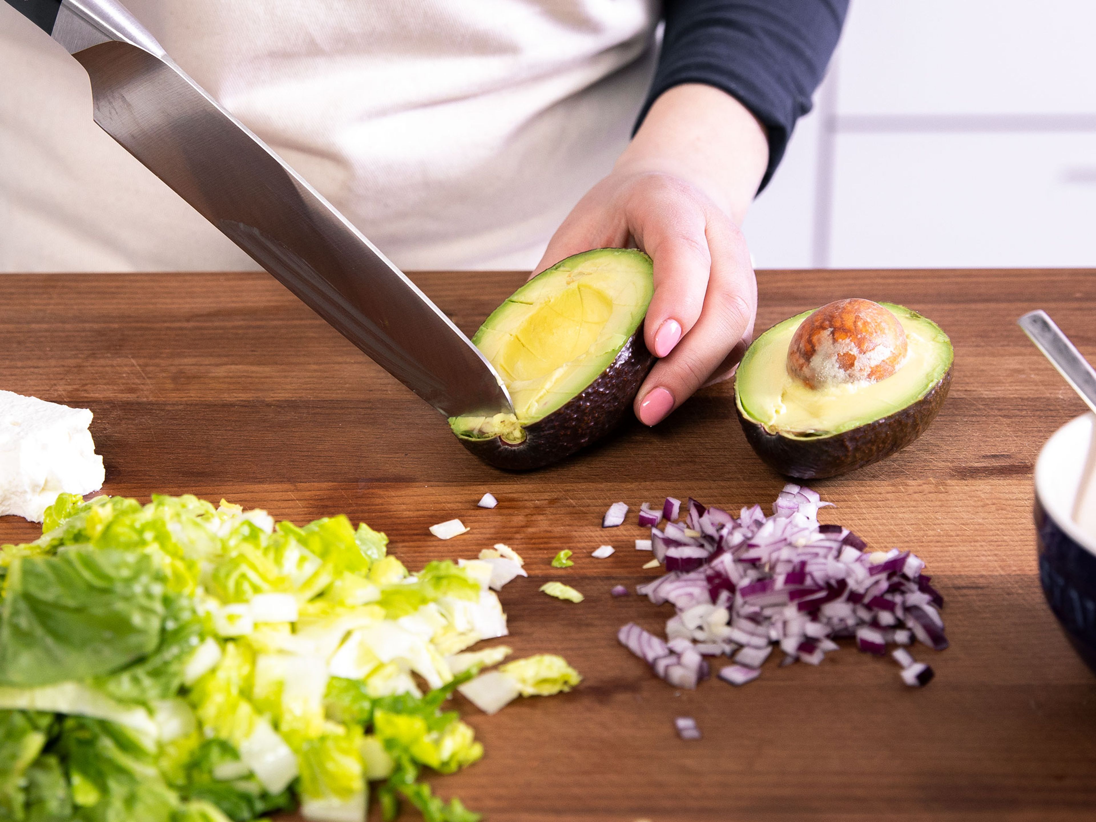 Chop avocado and romaine heart, and finely dice red onion. For the dressing, add olive oil, white wine vinegar, and honey to a small bowl. Stir to combine and season with salt and pepper to taste.