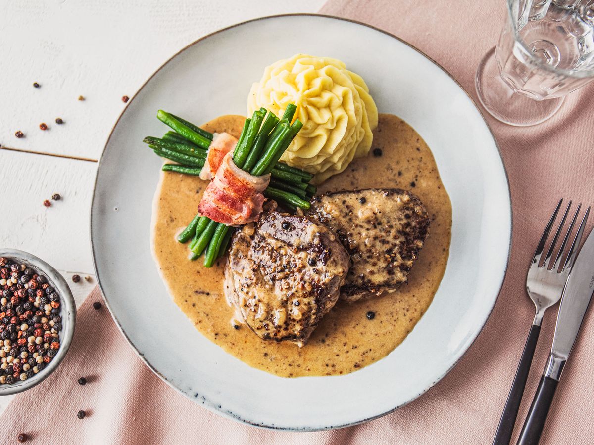 Classic steak au poivre (French pepper steak) with mashed potatoes and green bean bundles | Recipe |