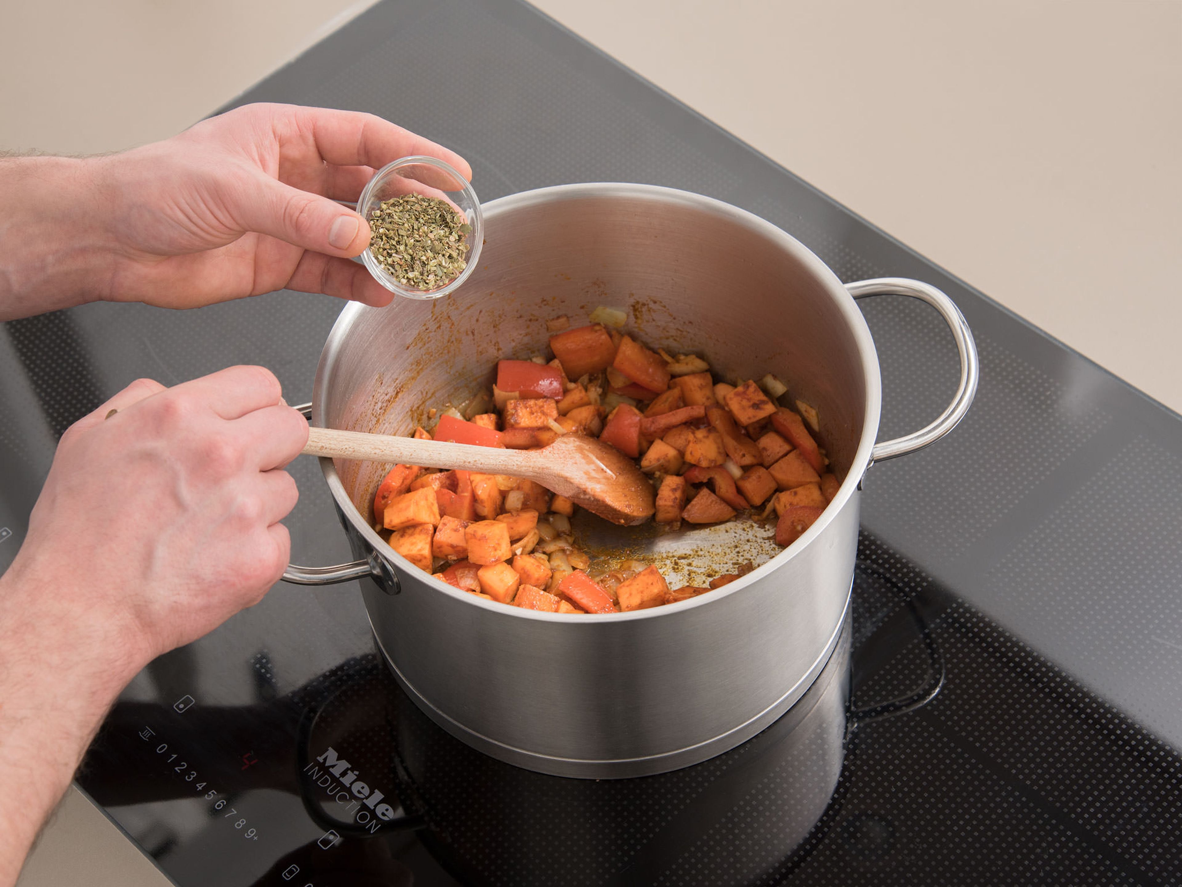Heat oil in a pot over medium-high heat and fry vegetables for approx. 3 min. Add chili powder, paprika powder, cayenne pepper, cumin, and oregano to the pot and mix well. Sauté for approx. 4 – 5 min.