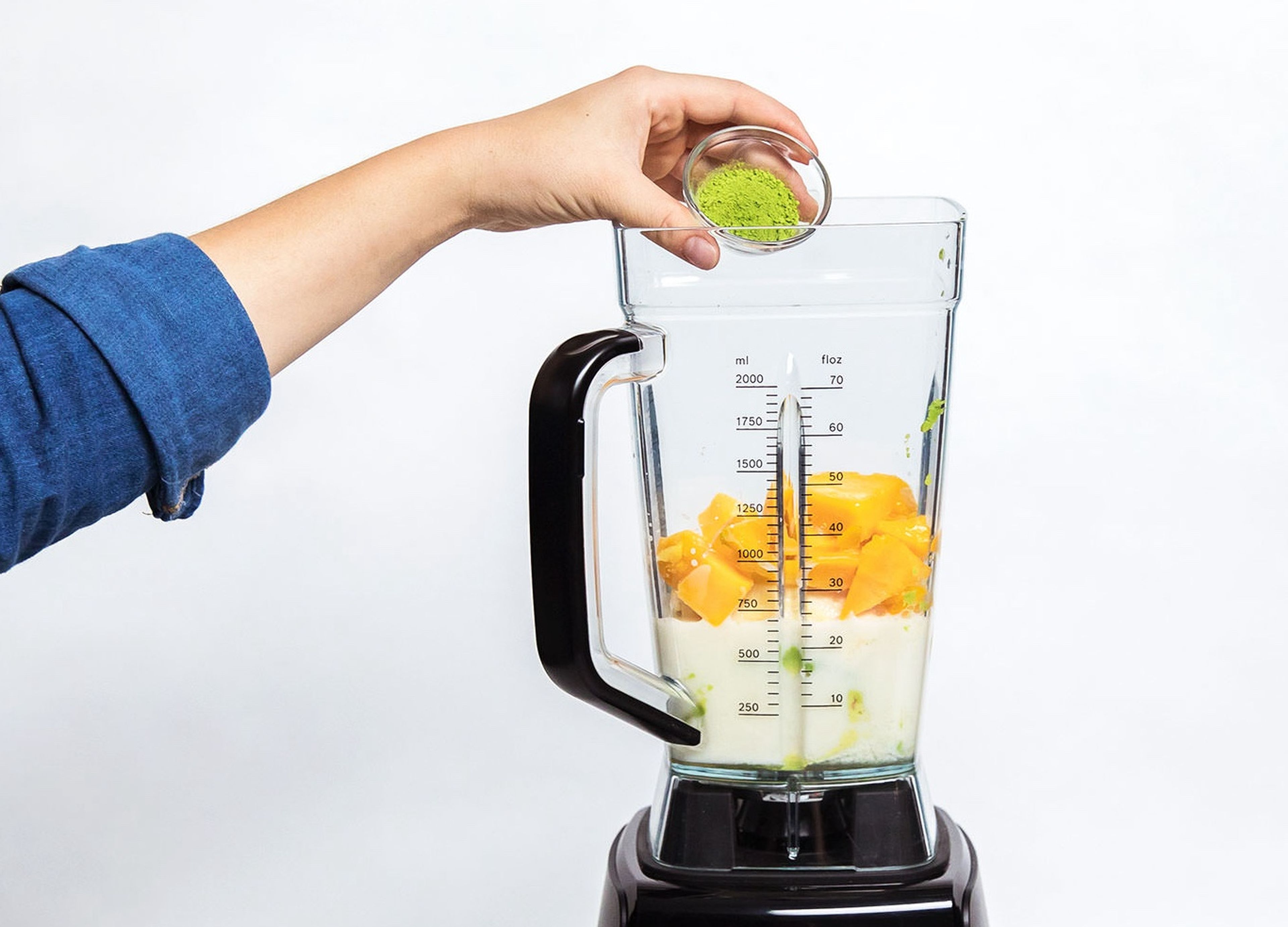 Halve the avocado and remove the seed. Scoop the flesh of both halves into the blender. Peel and add bananas to the blender with the frozen mango, freshly squeezed lime juice, agave nectar, almond milk, and matcha powder. Blend until smooth (using your blender's smoothie function).