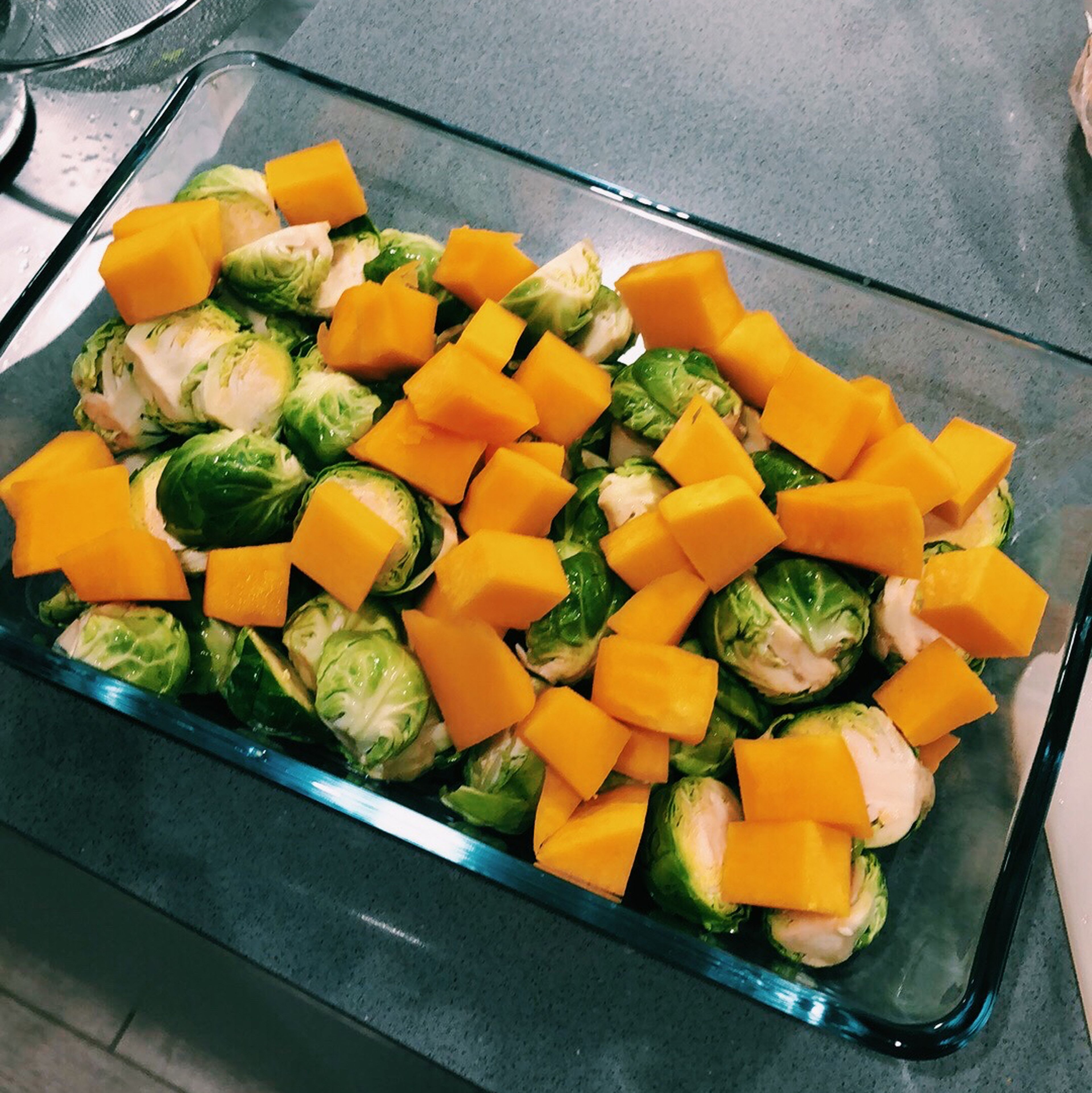 Prepare the vegetables and add to an oven proof dish. Coat in sesame oil and season to taste with salt and pepper.