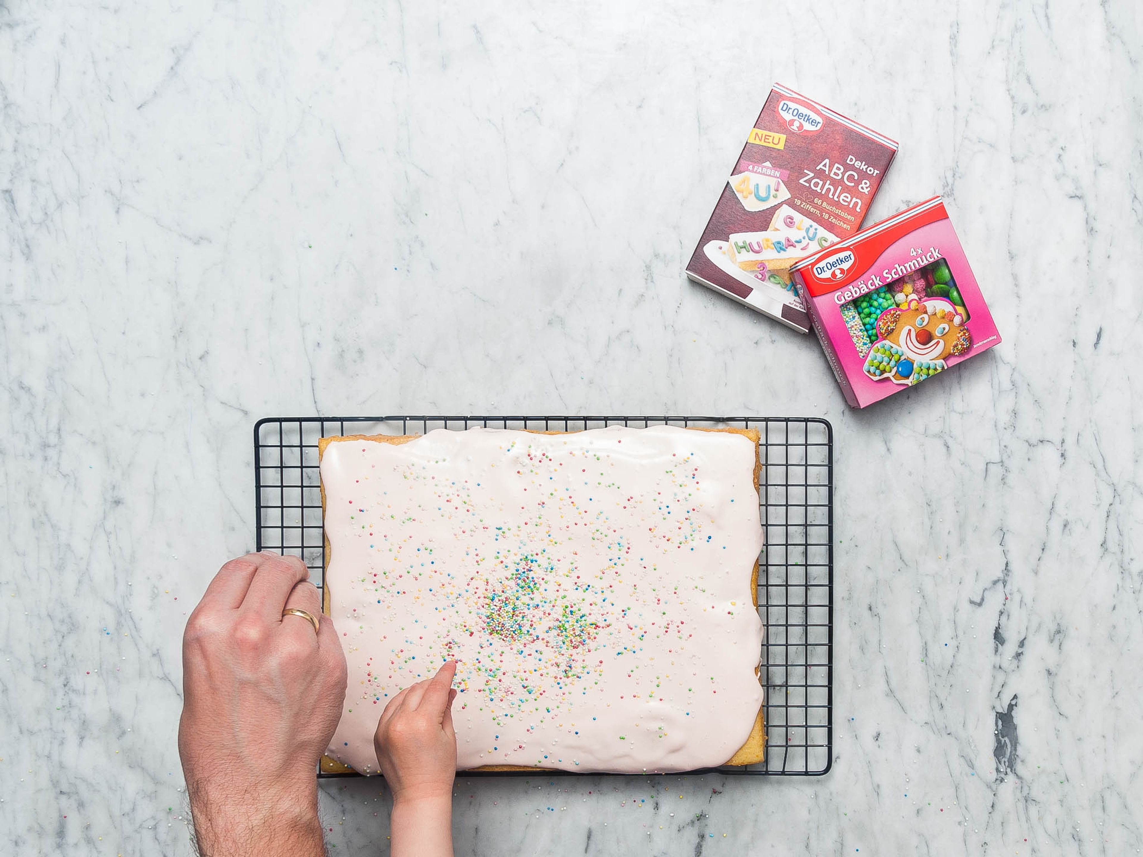 Smooth frosting over cake, decorate with sprinkles if desired, and enjoy!