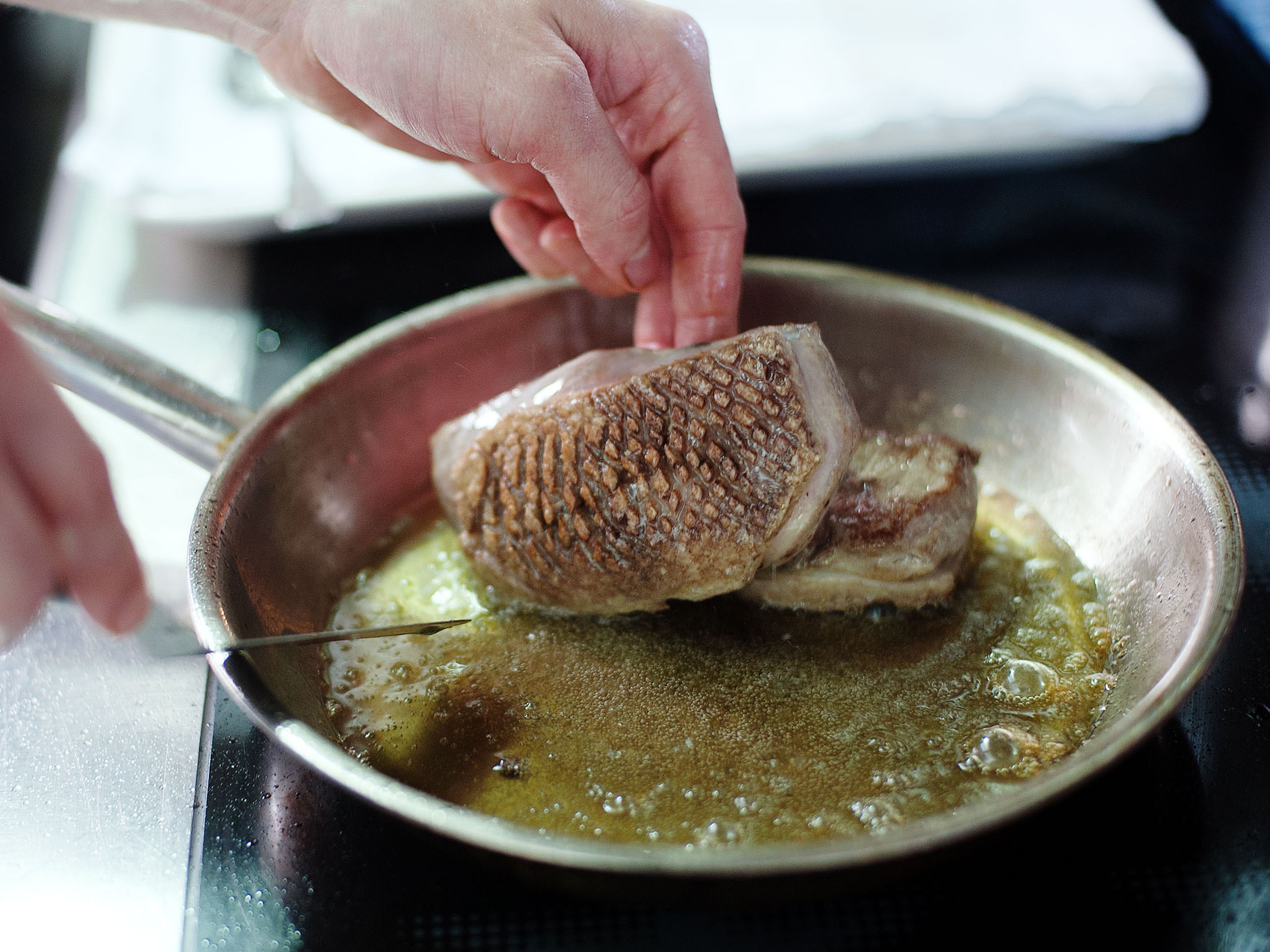 Heat oil in a frying pan set over medium-high heat. Sear duck breast. Spoon hot oil over the skin, then flip duck breast. Remove from frying pan and let oil drain from meat.