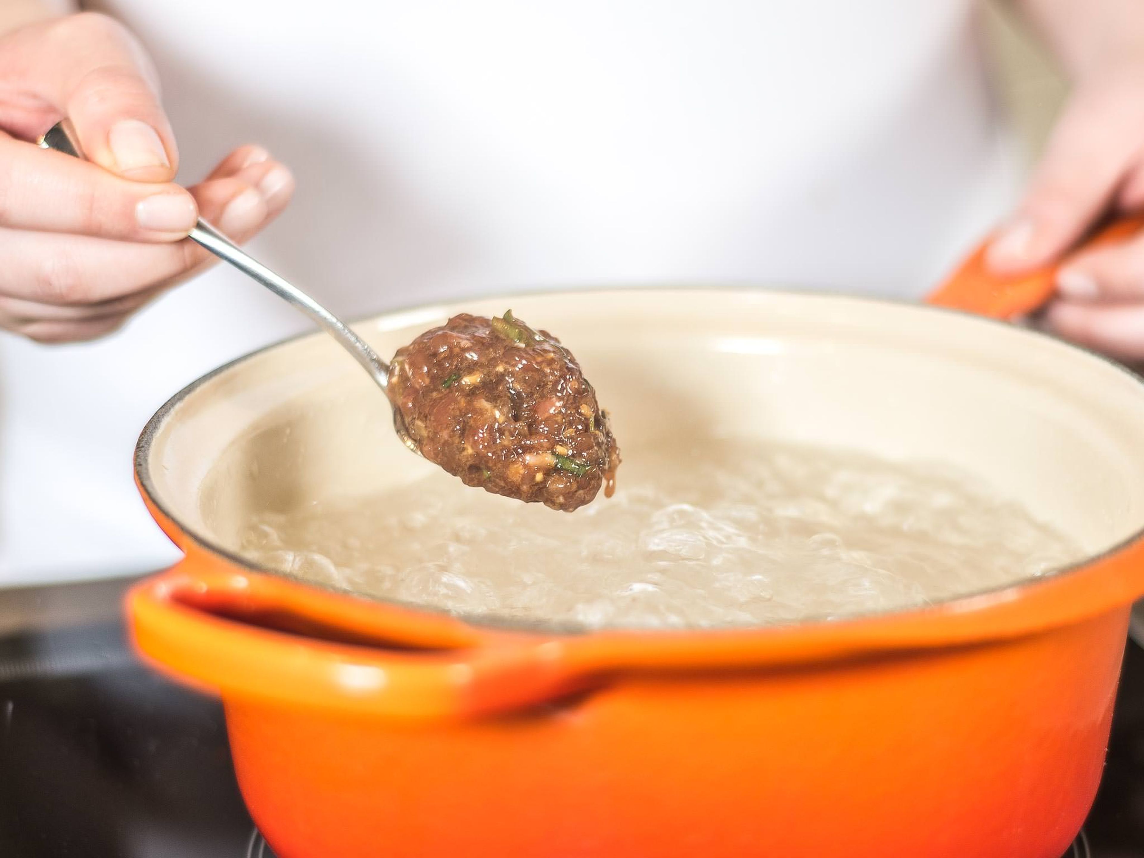 Now, put the meat balls into the boiling water using a spoon.